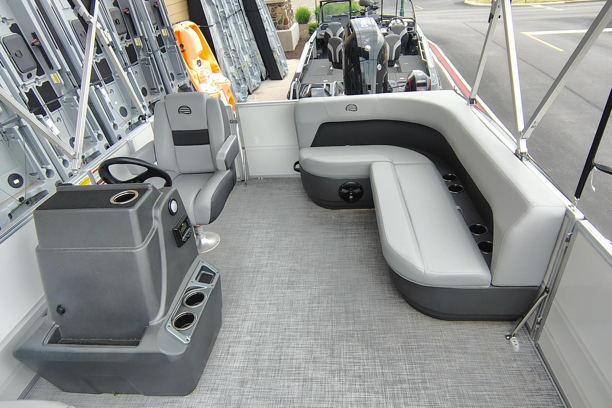 2026 Sun Tracker Party Barge 16 DLX interior with seating and steering console.