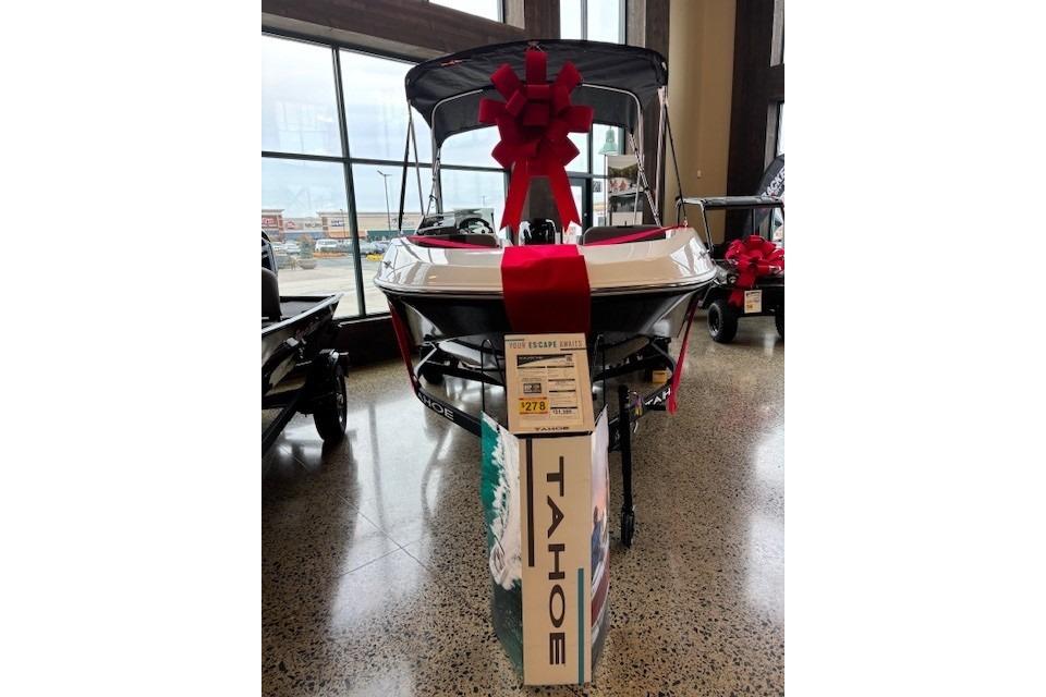 2026 Tahoe T16 boat displayed indoors with a large red bow.