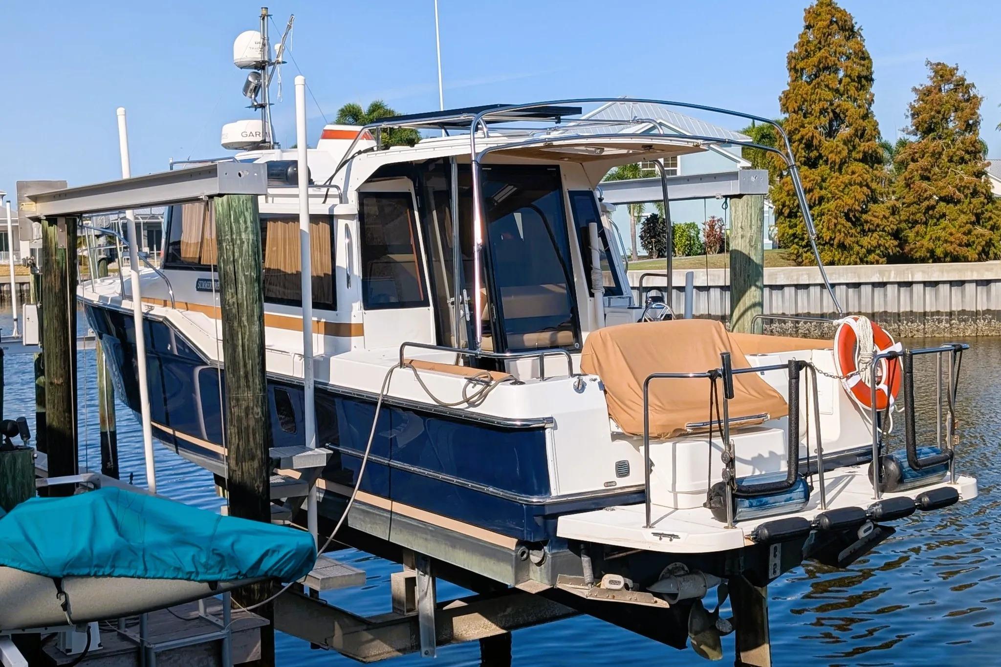 2015 Ranger Tugs R-29 S docked, featuring sleek design and modern amenities.