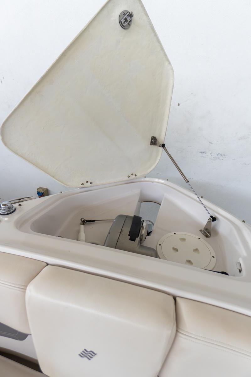 2018 Four Winns 290 Horizon boat storage compartment with open hatch.