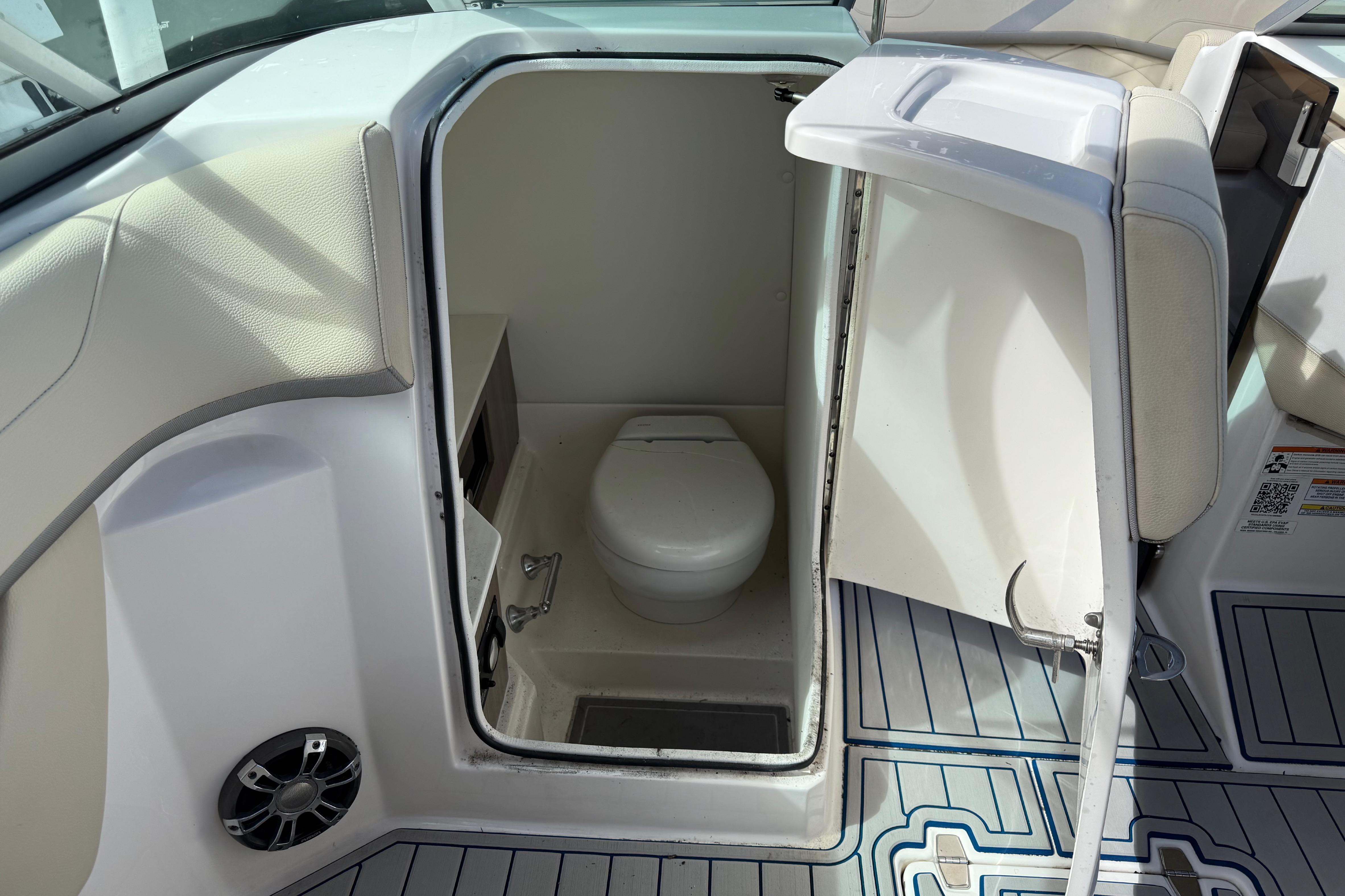 2021 Regal 26 OBX boat interior with compact marine toilet.