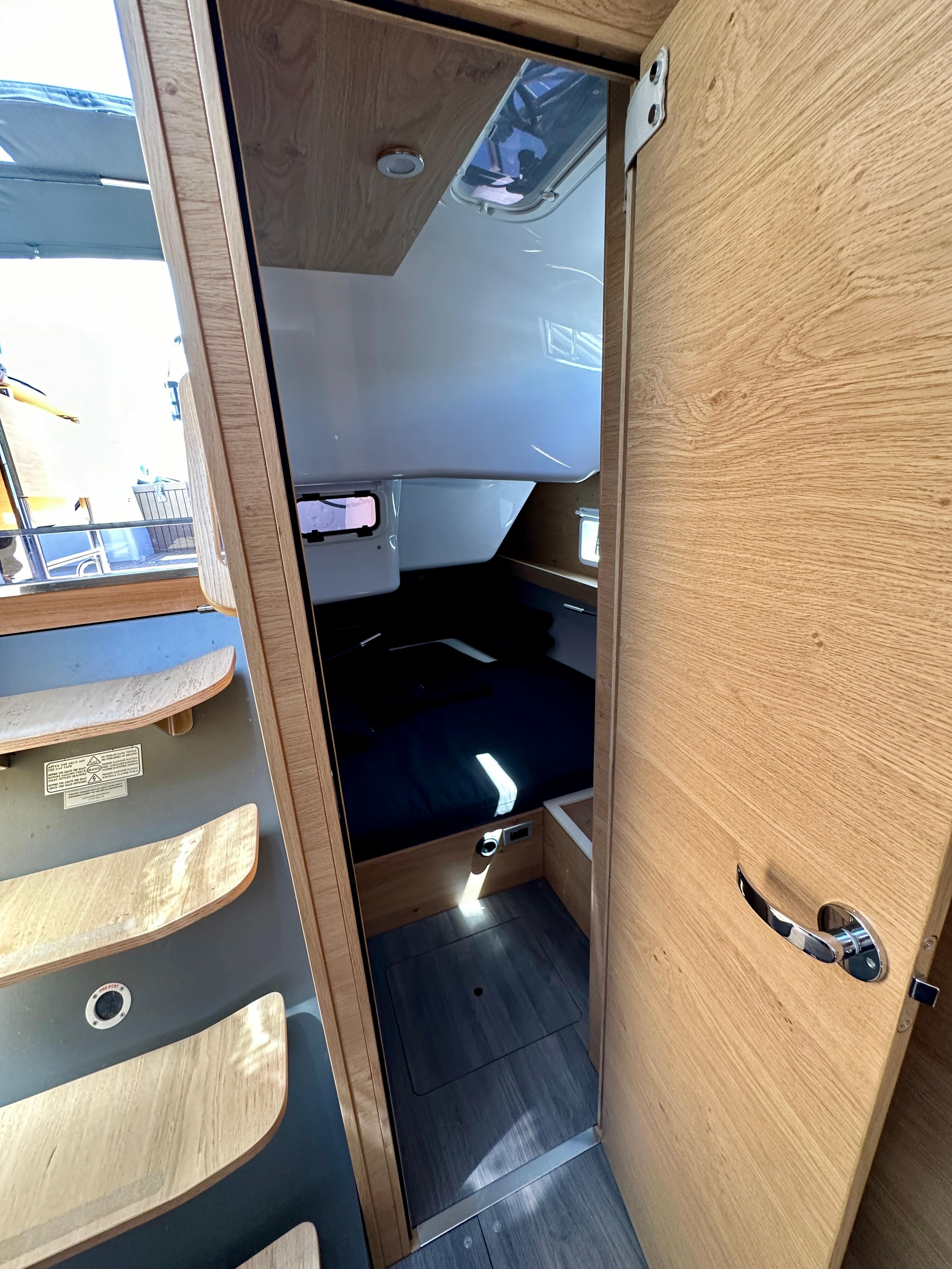 Interior of 2024 Elan Impression 43 yacht, featuring modern wood finishes and cozy cabin space.