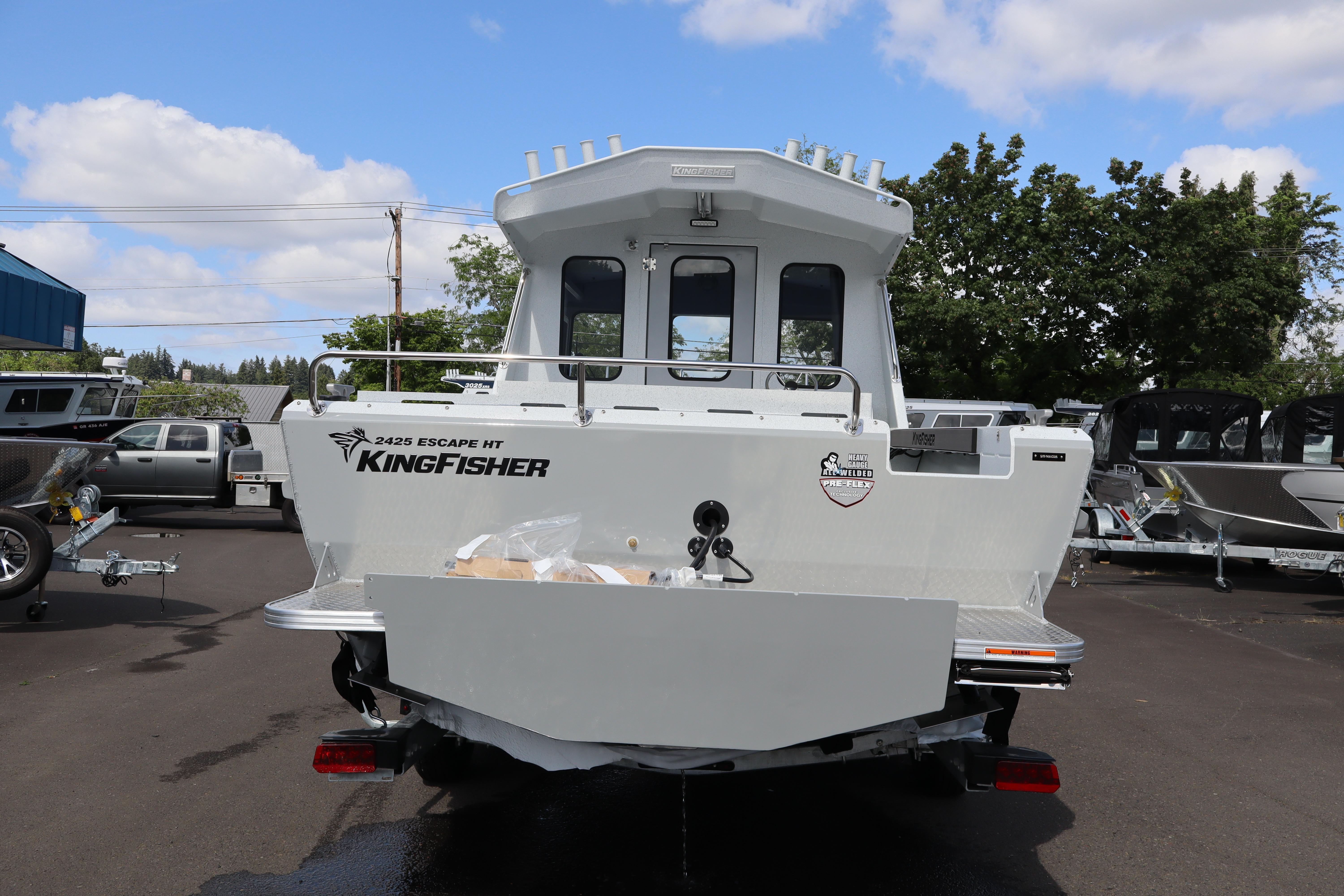 2026 KingFisher 2425 Escape HT boat, rear view, parked outdoors under a blue sky.