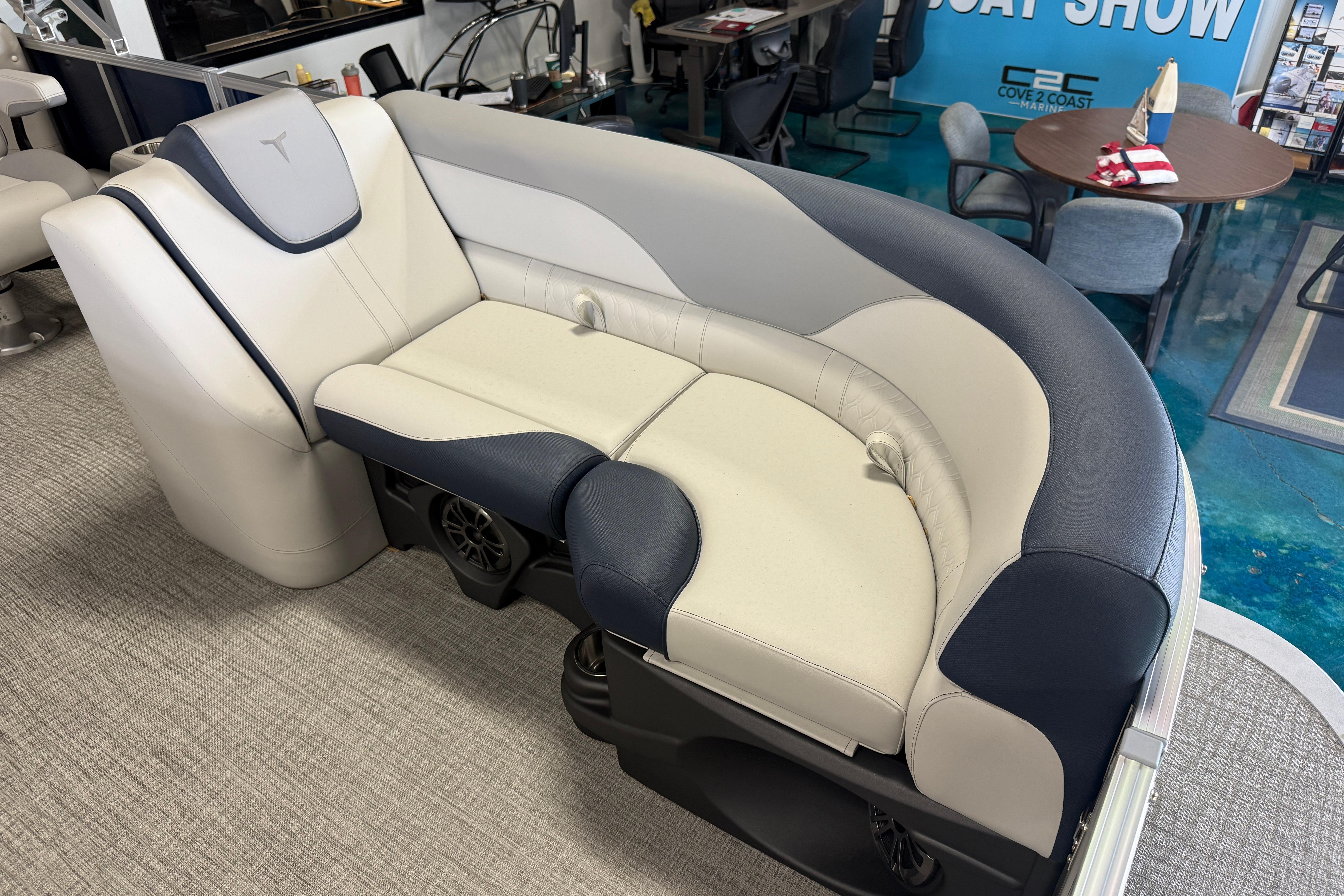 2026 Tahoe Pontoon LTZ Quad Lounger with plush seating at a boat show.