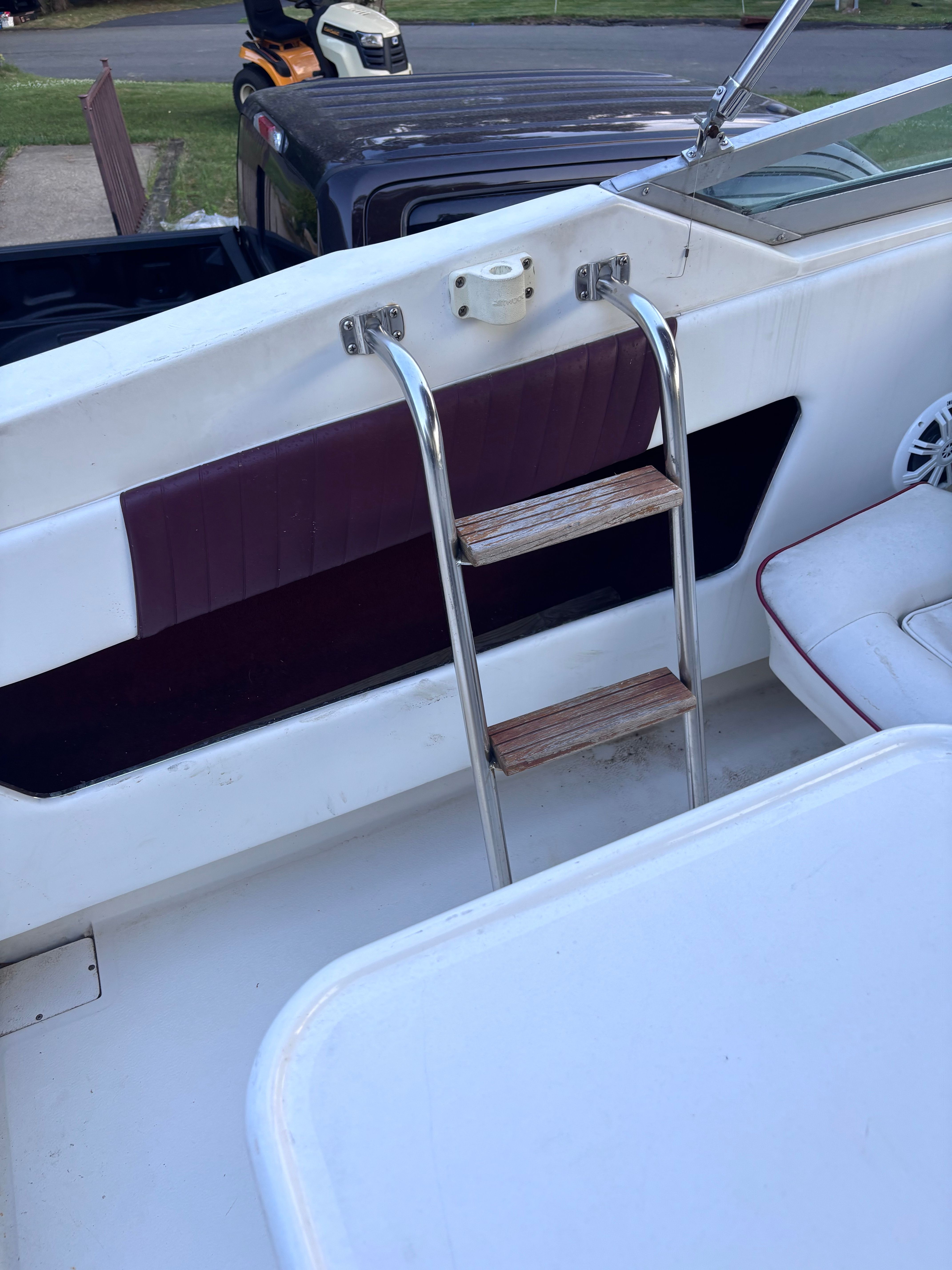 A ladder with wooden steps leads to an elevated area on a boat.