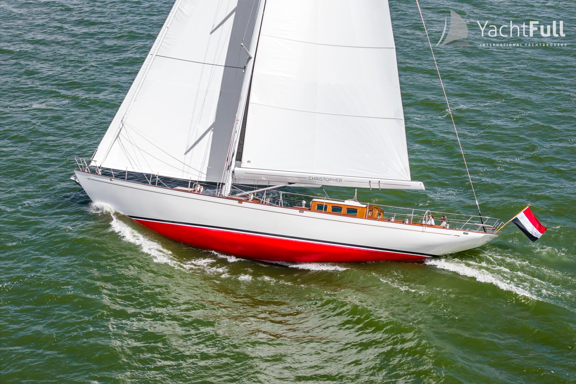 Sailing yacht Dykstra 73, 2025 model, with red hull on open water.