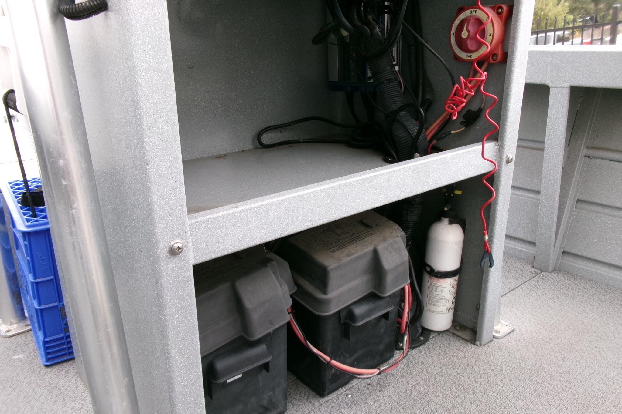 2017 Klamath Bayrunner 19 Baja boat interior showing battery compartment and wiring.