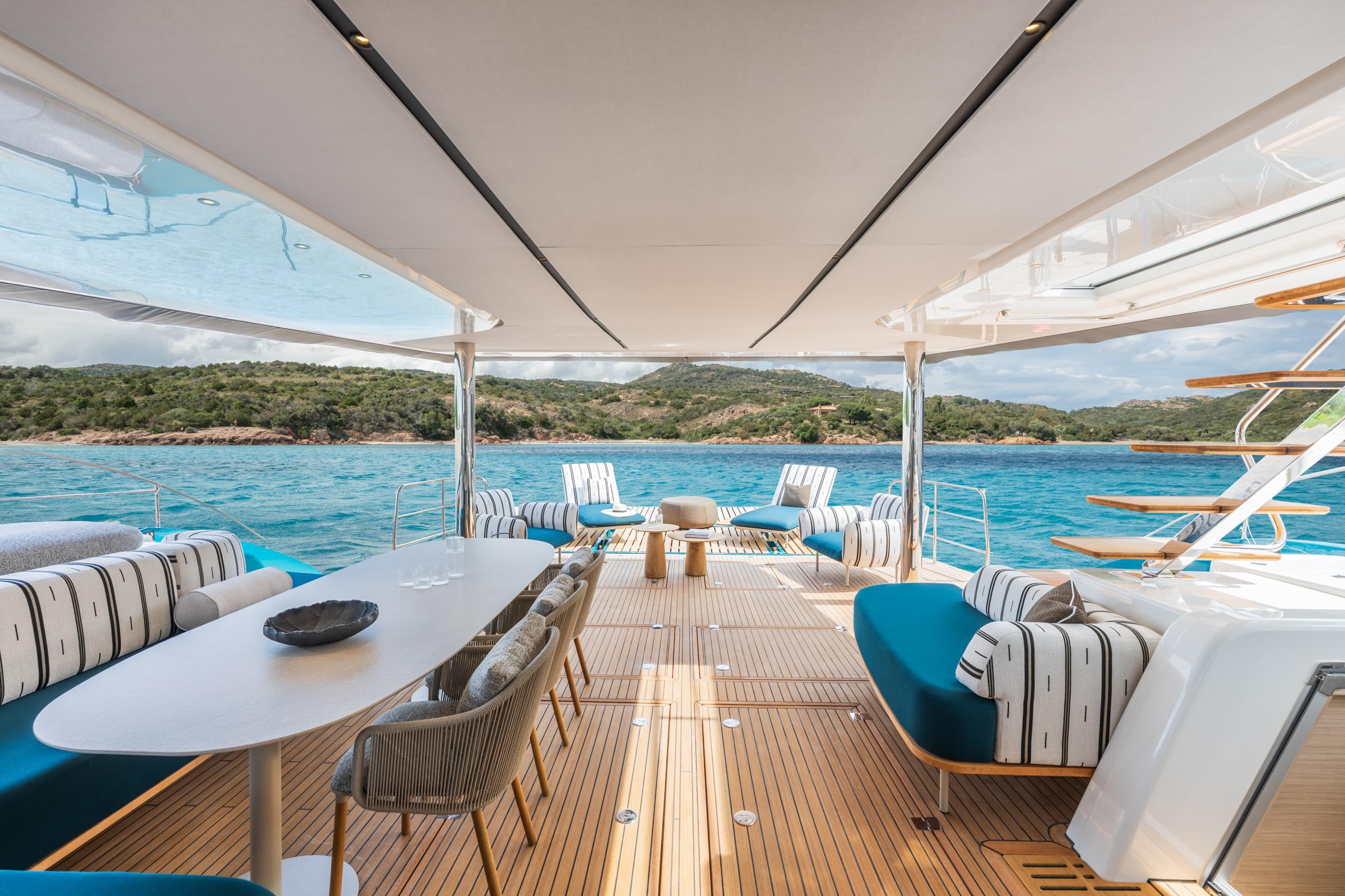 Luxurious Lagoon Eighty 2 yacht interior with ocean view, featuring elegant seating and modern design.