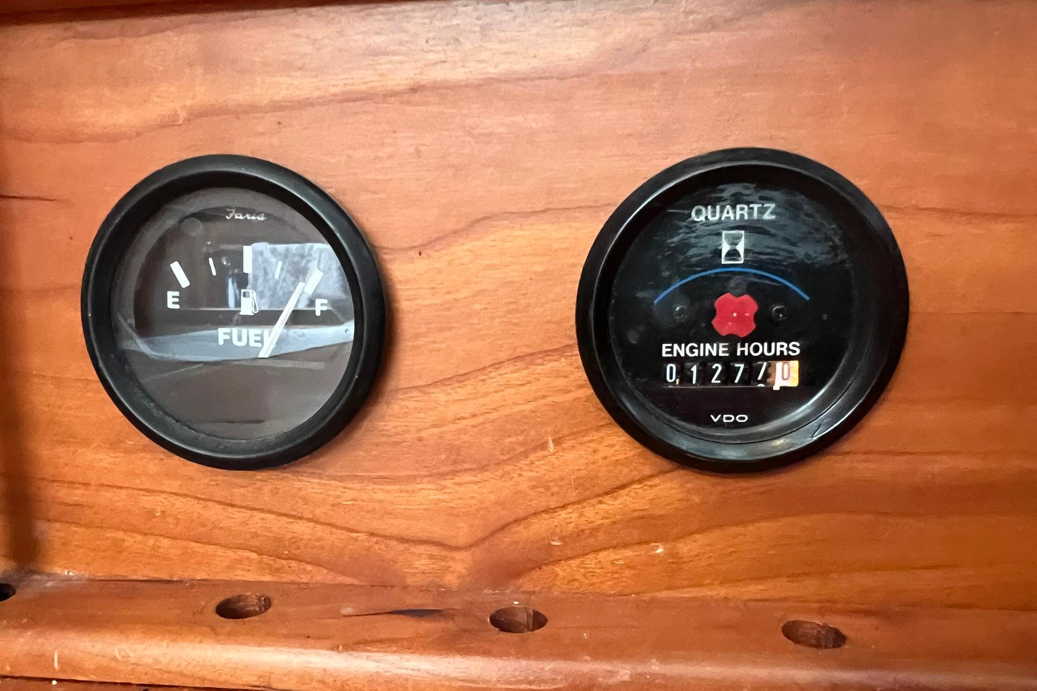Fuel and engine hour gauges on a 1998 Sabre 362 boat dashboard.