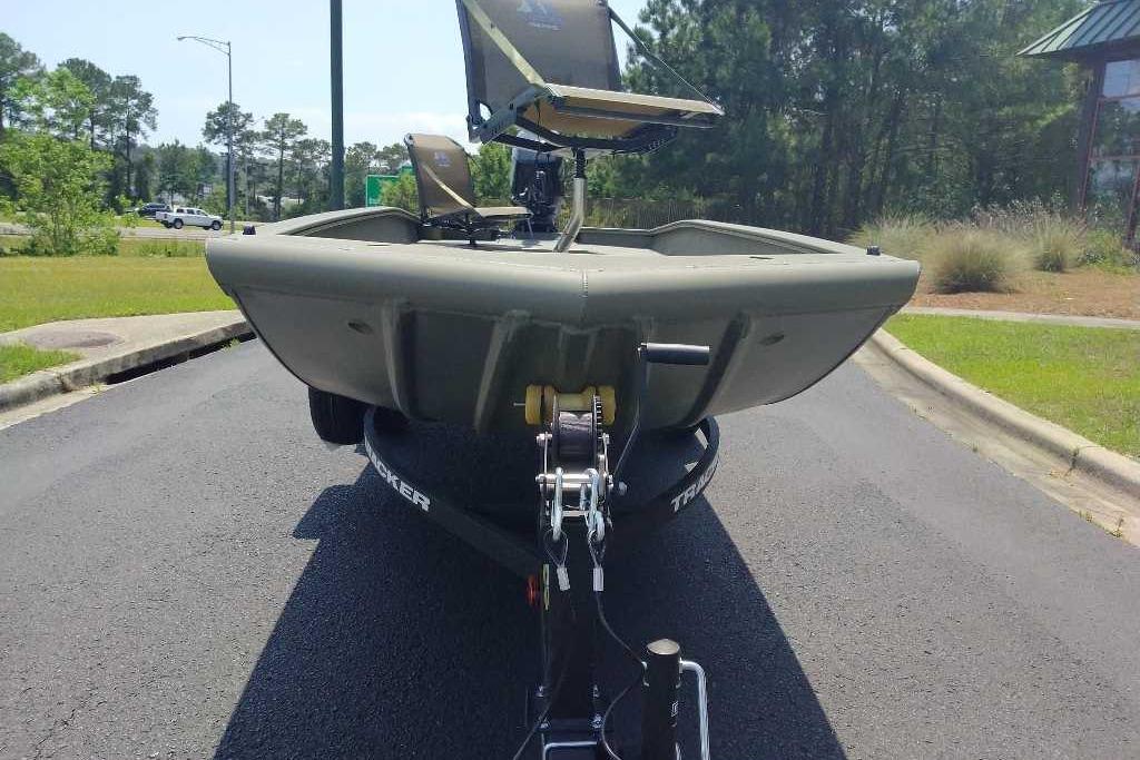 2026 Tracker Grizzly 1650 T Prairie Wings Edition boat on trailer, parked outdoors.