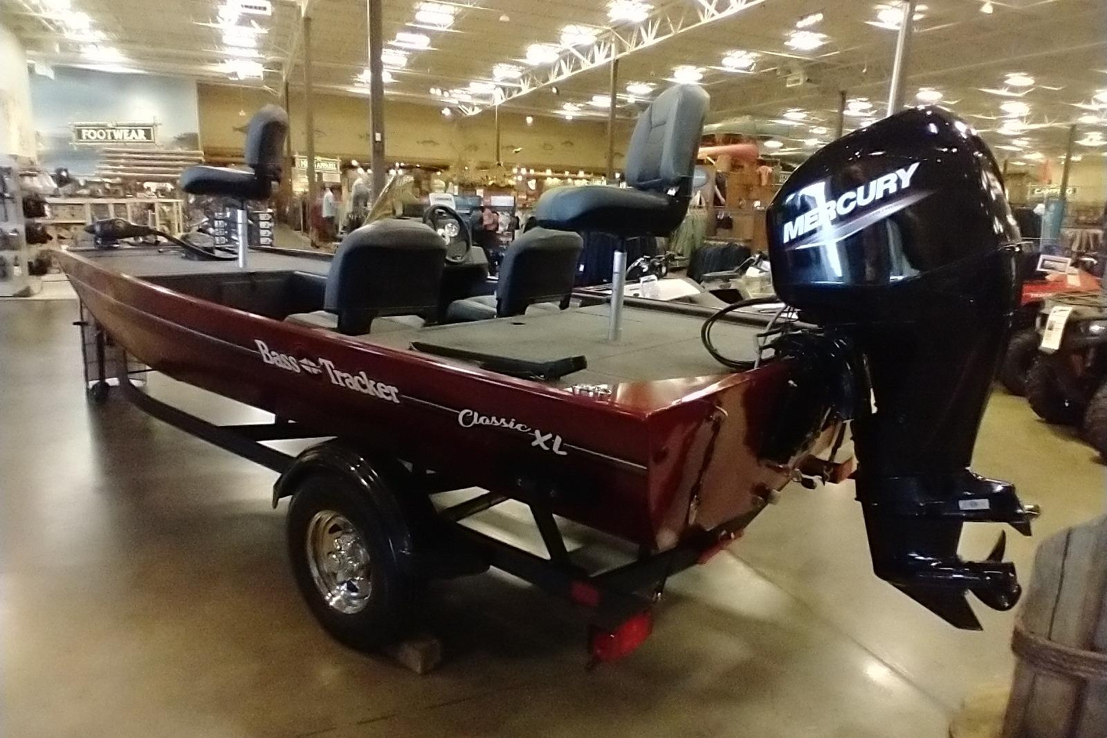 2026 Tracker Bass Tracker Classic XL boat with Mercury engine displayed indoors.