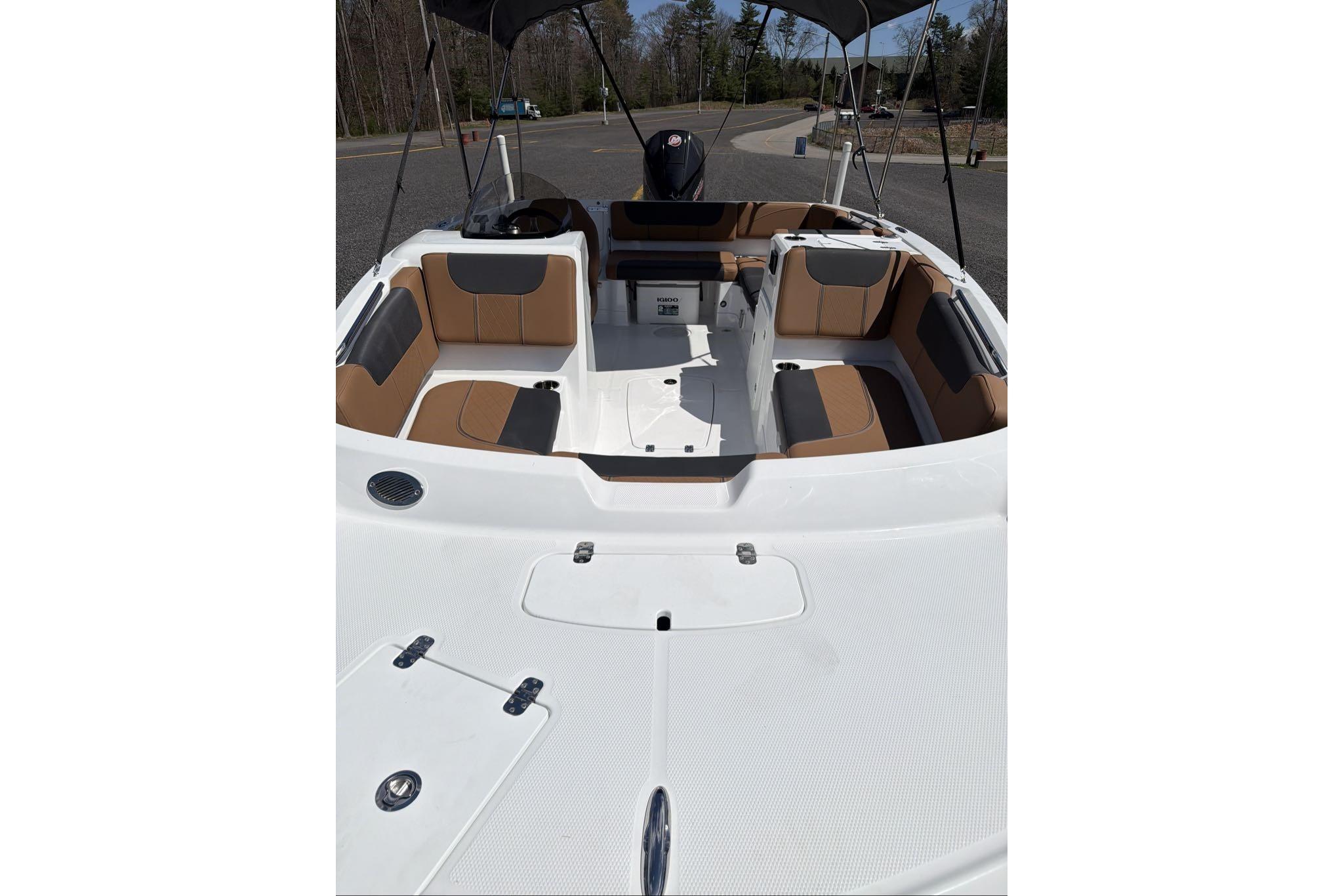 2026 Tahoe 1950 boat interior with tan and black seating, open deck, and canopy.