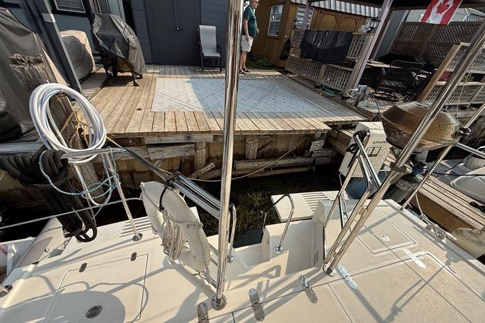 2007 Island Pilot 395 yacht docked at a wooden pier with outdoor seating.