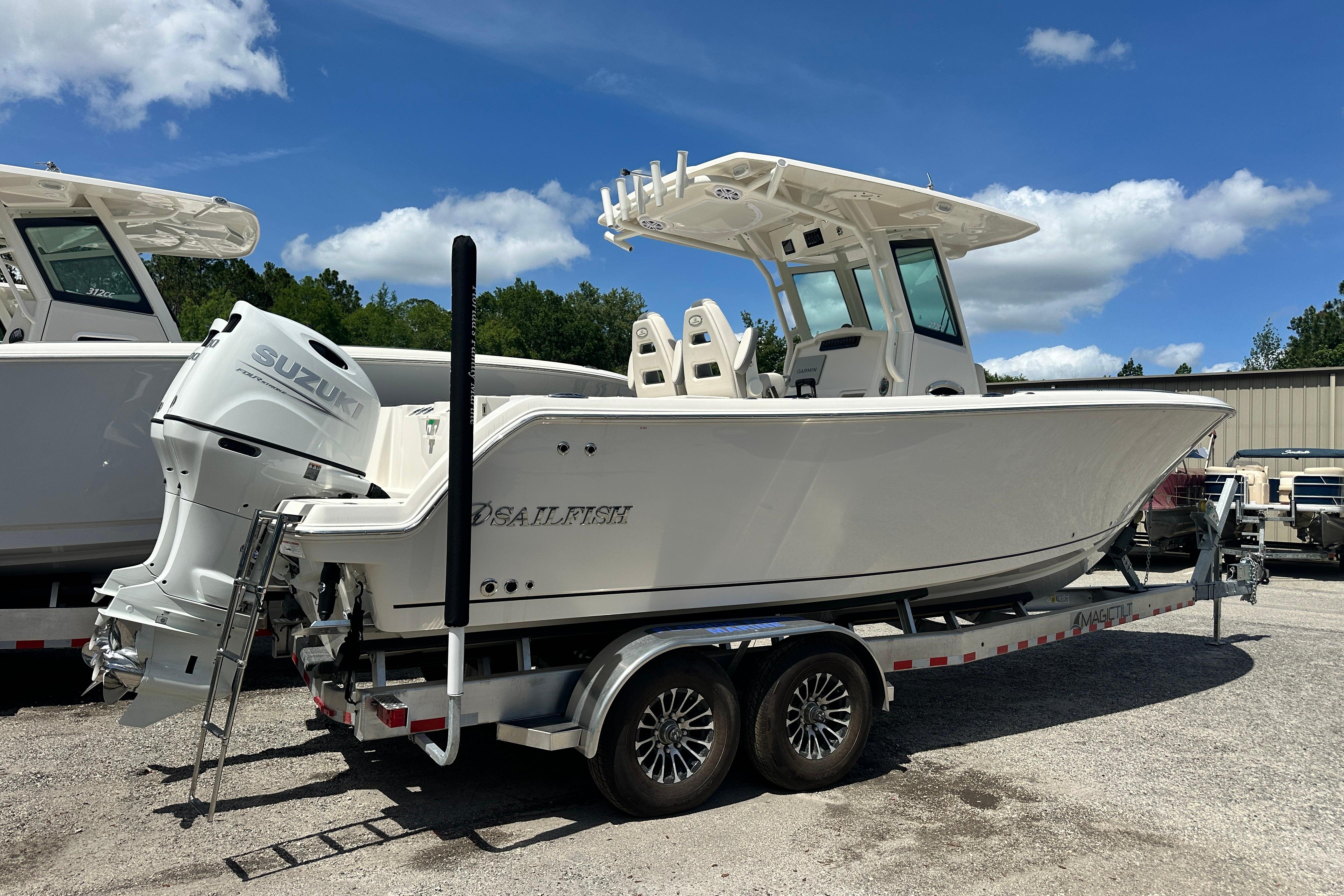 2026 Sailfish 272 CC boat on trailer, featuring Suzuki outboard motor, under clear blue sky.