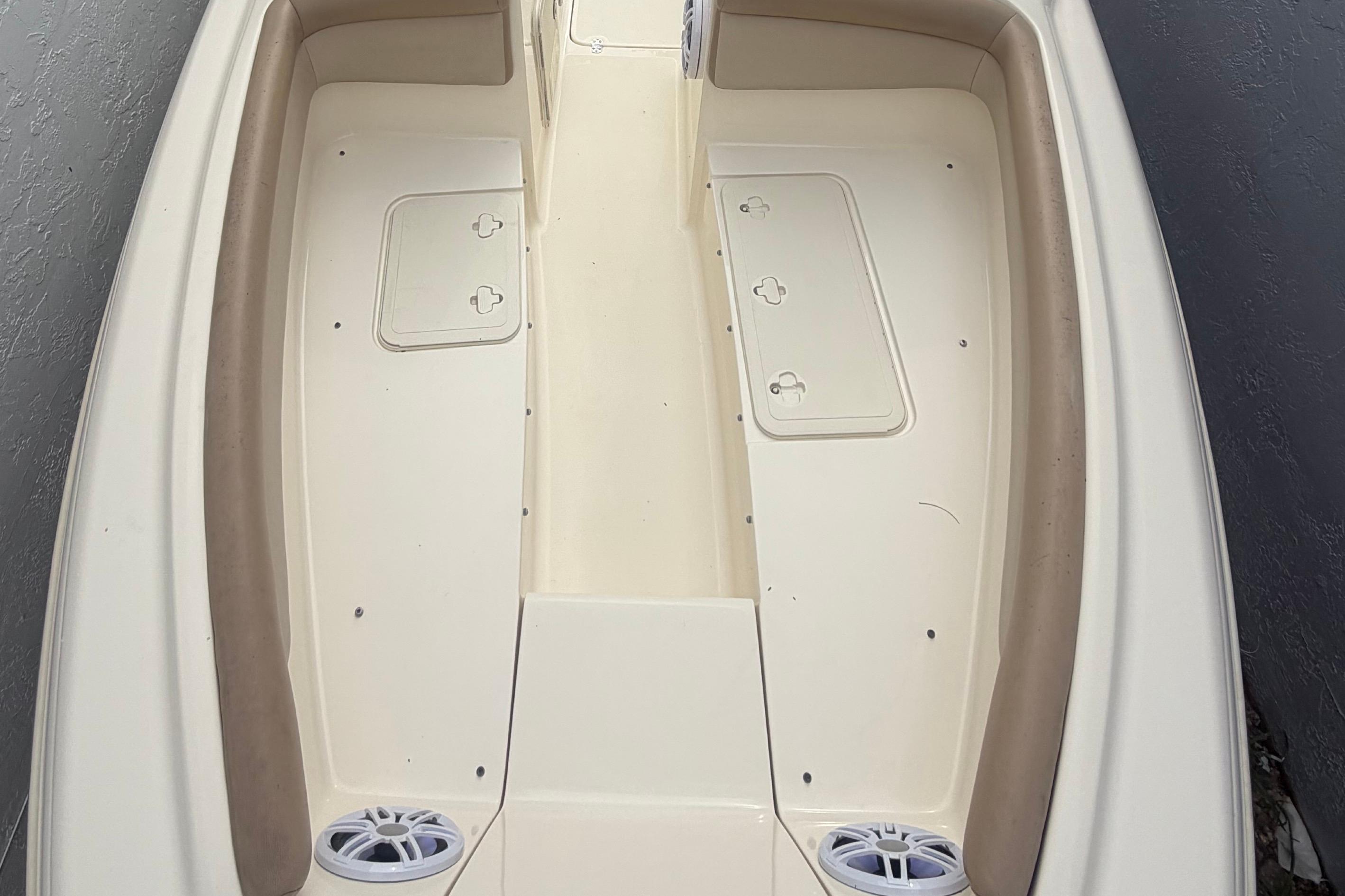 2023 Scout 210 Dorado boat interior with beige seating and storage compartments.