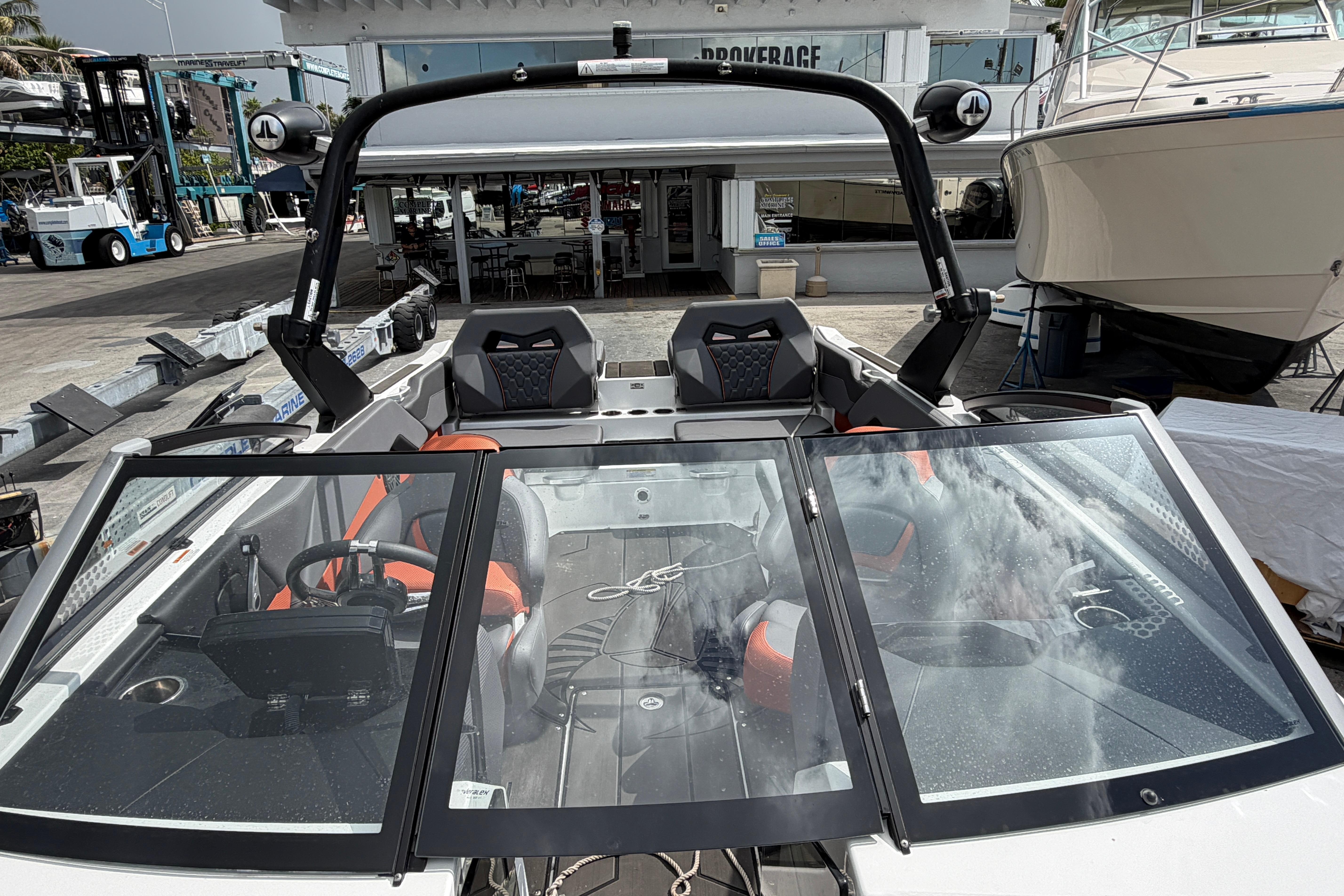 2026 Scarab 235 LX boat interior with modern seating and sleek design at a marina.