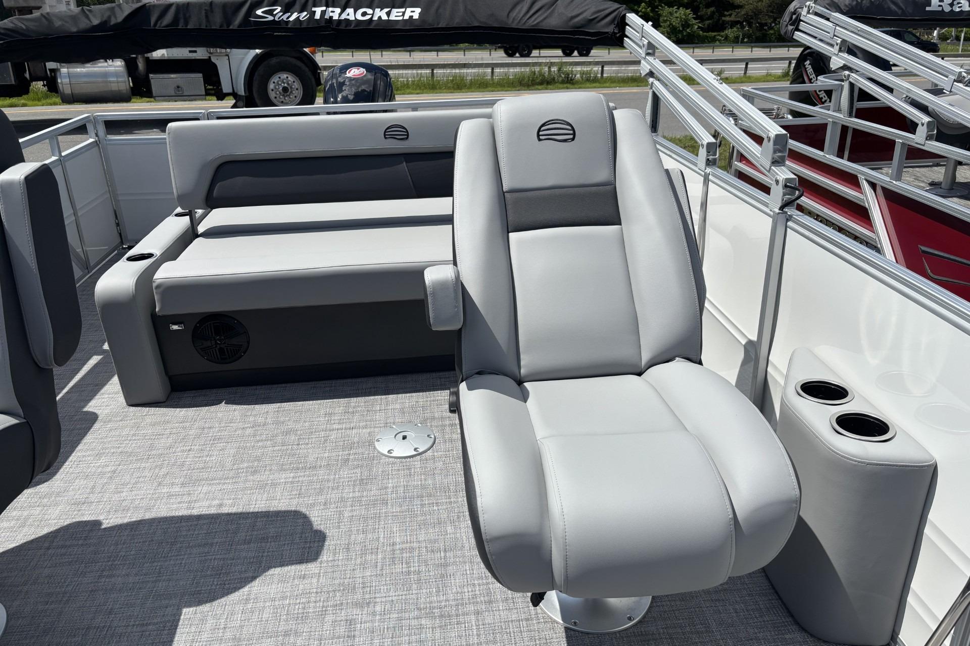 2026 Sun Tracker Party Barge 22 RF DLX interior with gray seating and cup holders.