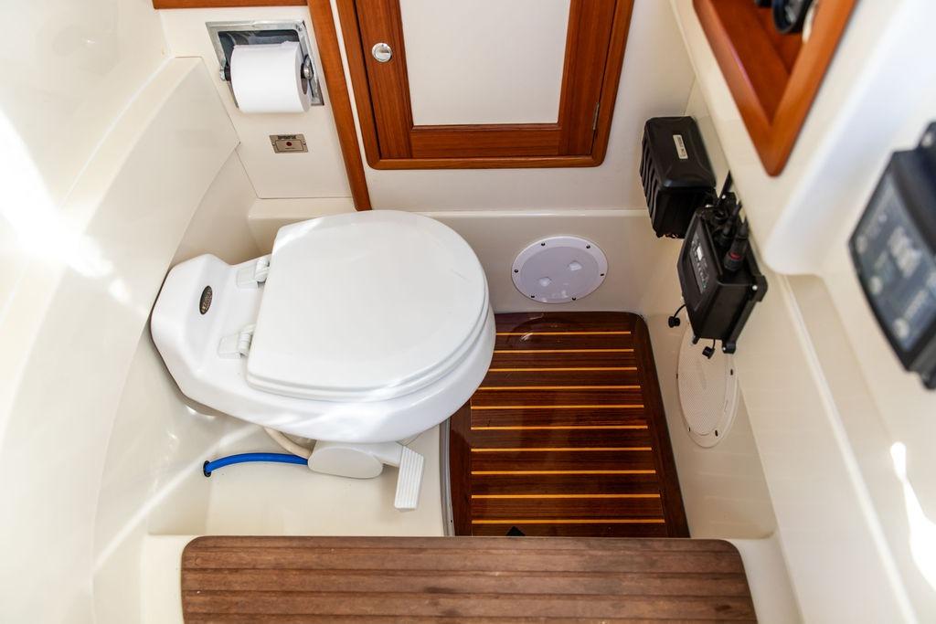 Hinckley Talaria 29C 2002 boat bathroom with wooden flooring and modern amenities.
