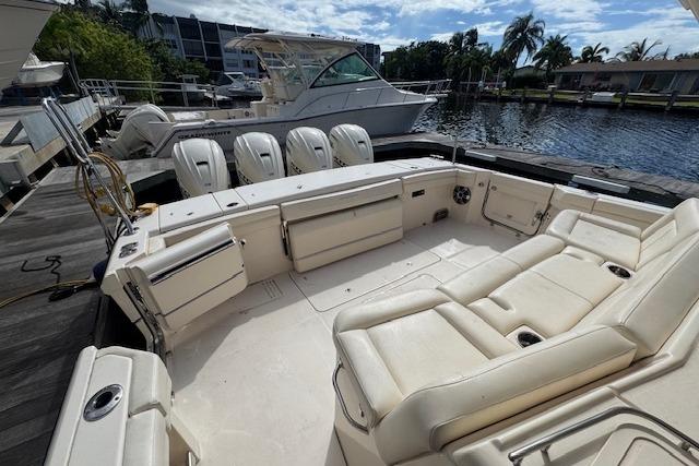 2024 Grady-White Canyon 456 boat with spacious seating and four outboard engines.