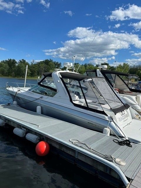 2006 Formula 330 Sun Sport boat docked on a sunny day.