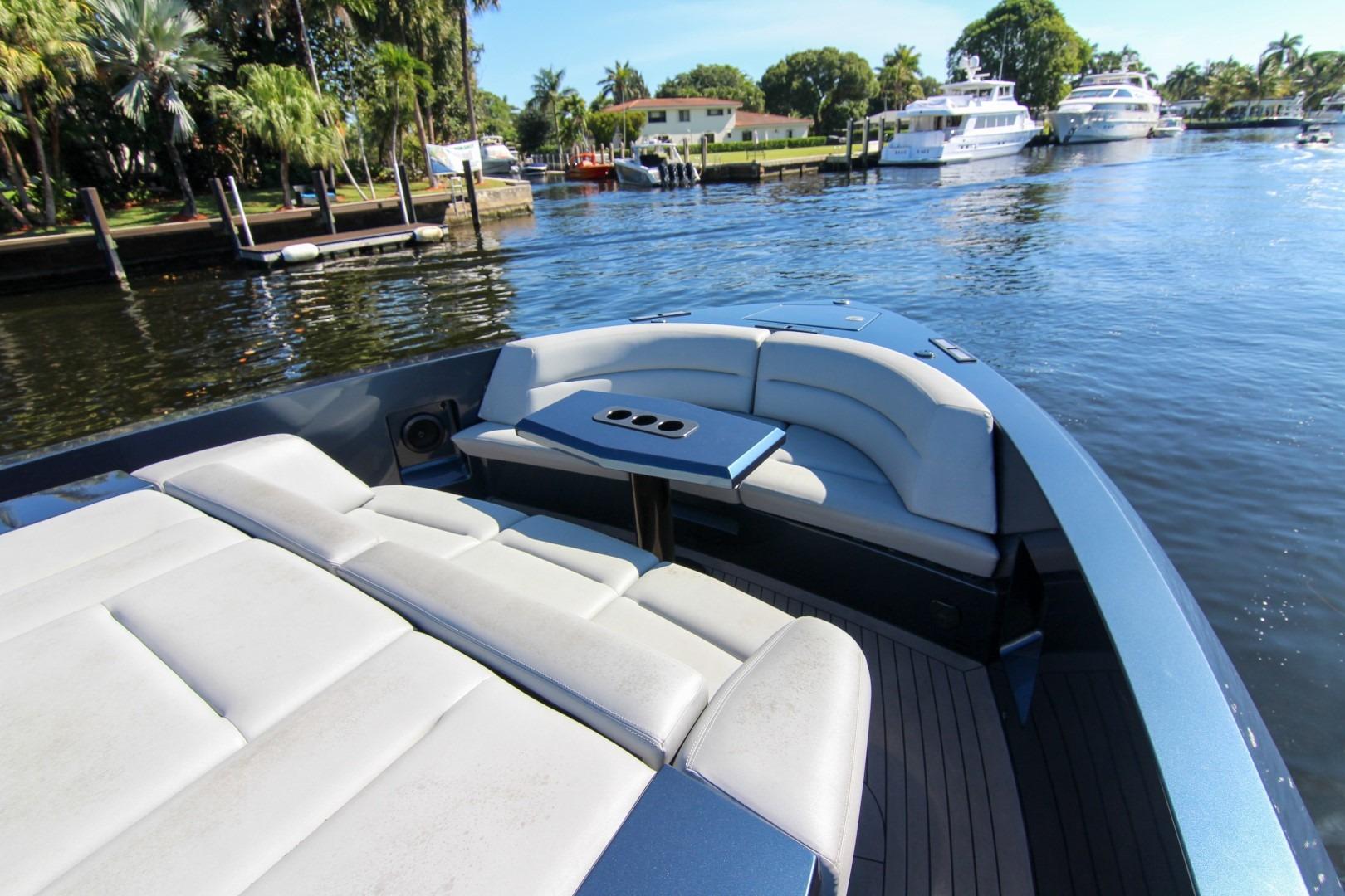 Luxurious 2022 Vanquish Yachts VQ45 with elegant seating on a serene waterfront.