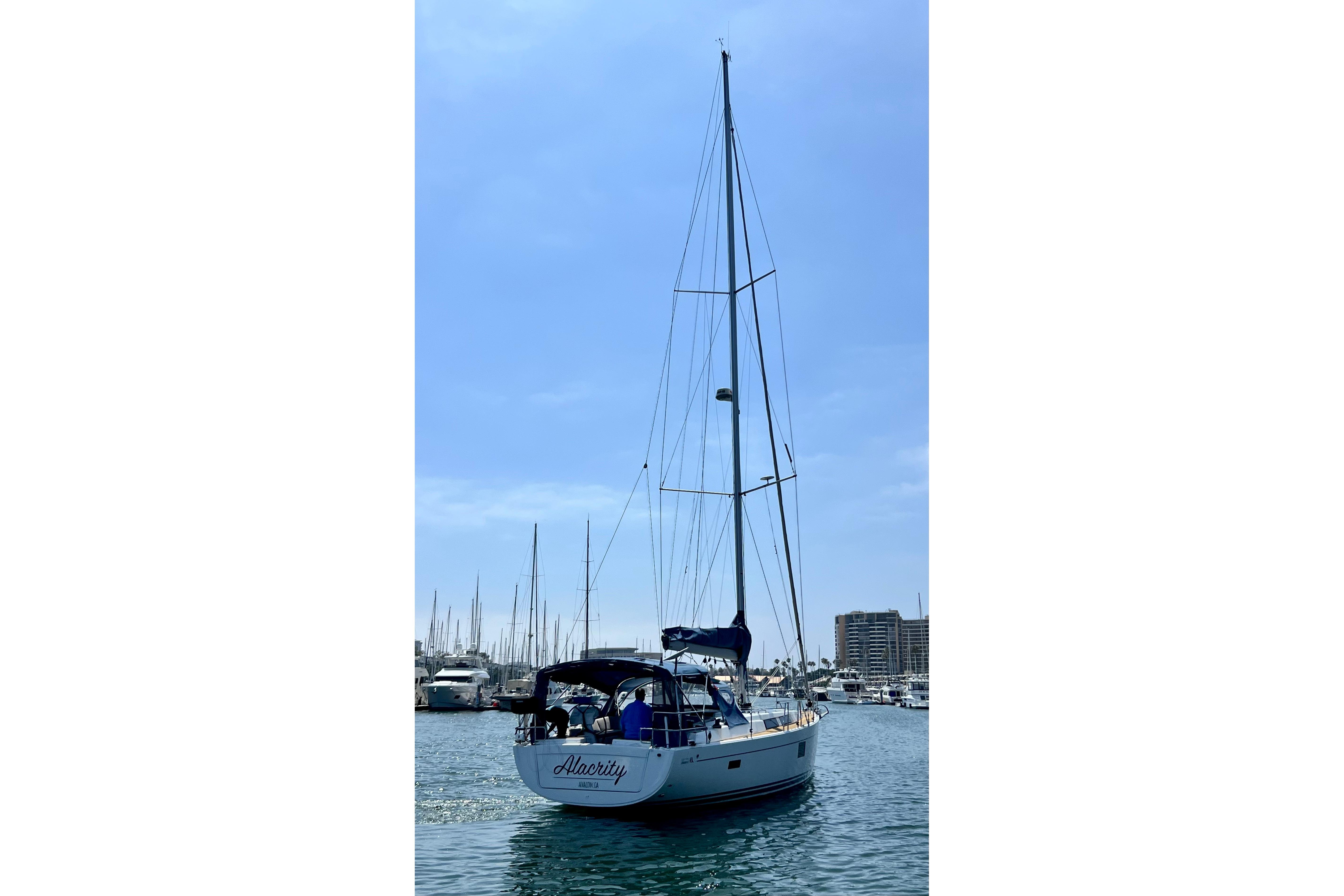 Sailing yacht Hanse 455, 2016 model, docked in a marina under a clear blue sky.