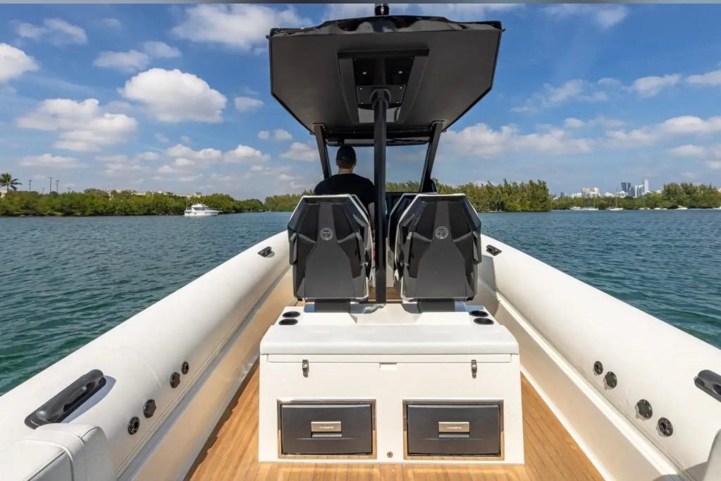 2025 Technohull GTX boat on water, featuring dual seats and sleek design.