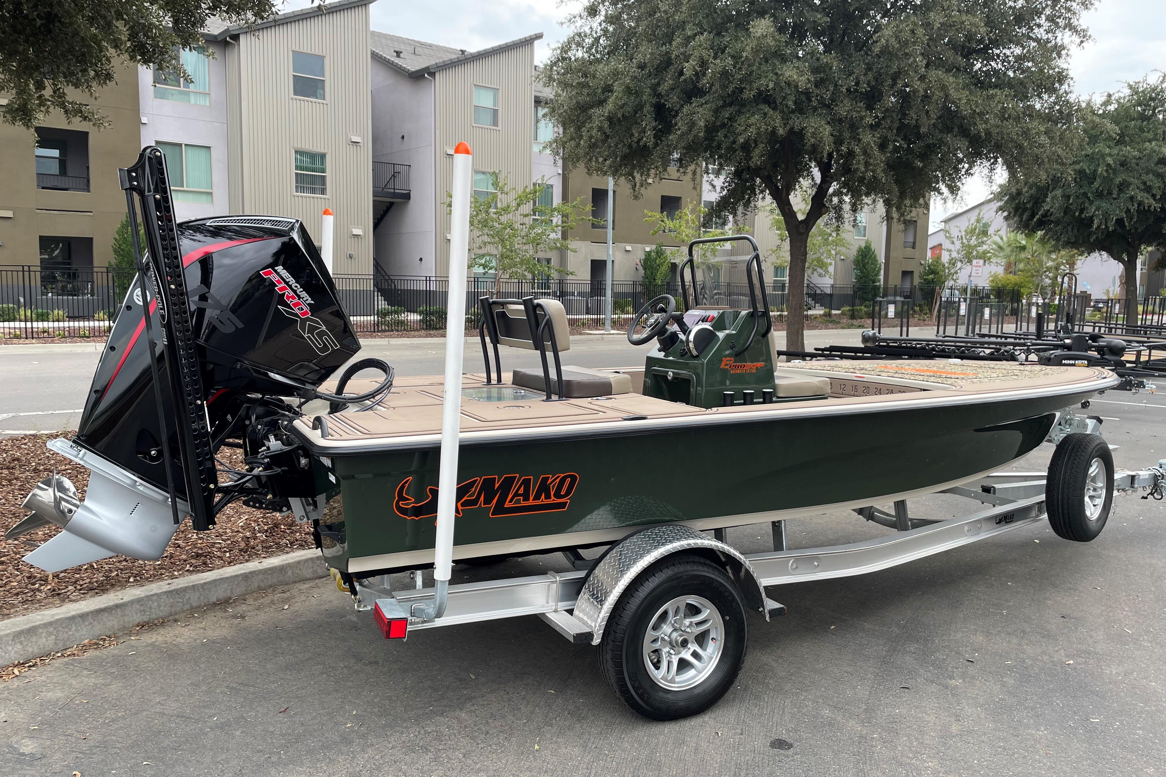 2025 Mako 18 Pro Skiff Backwater Edition on trailer, parked outdoors.