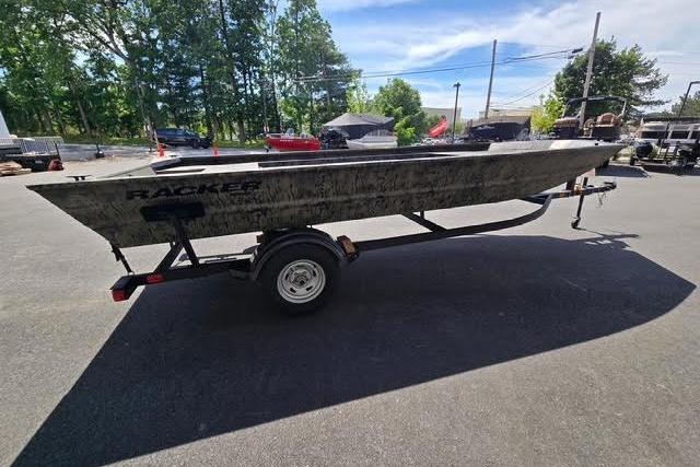 2026 Tracker Grizzly 1860 Utility boat on trailer, parked outdoors.