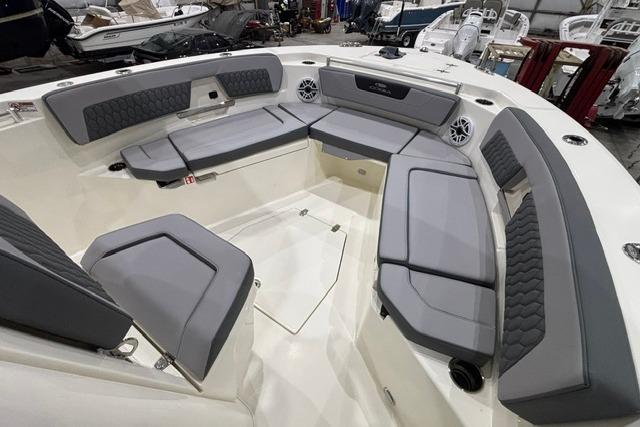 2026 Cobia 245 Center Console boat interior with gray cushioned seating and modern design.