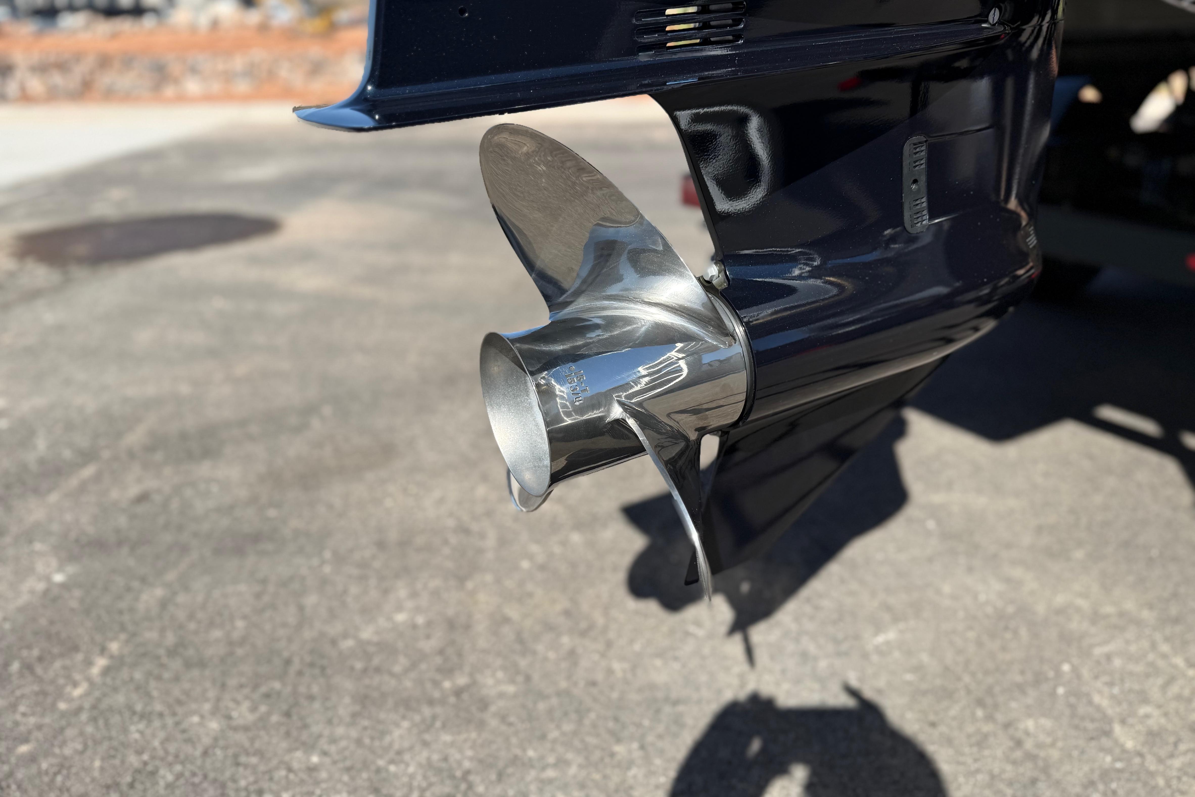 Close-up of a SunCatcher Select 322SL 2026 boat propeller on a sunny day.