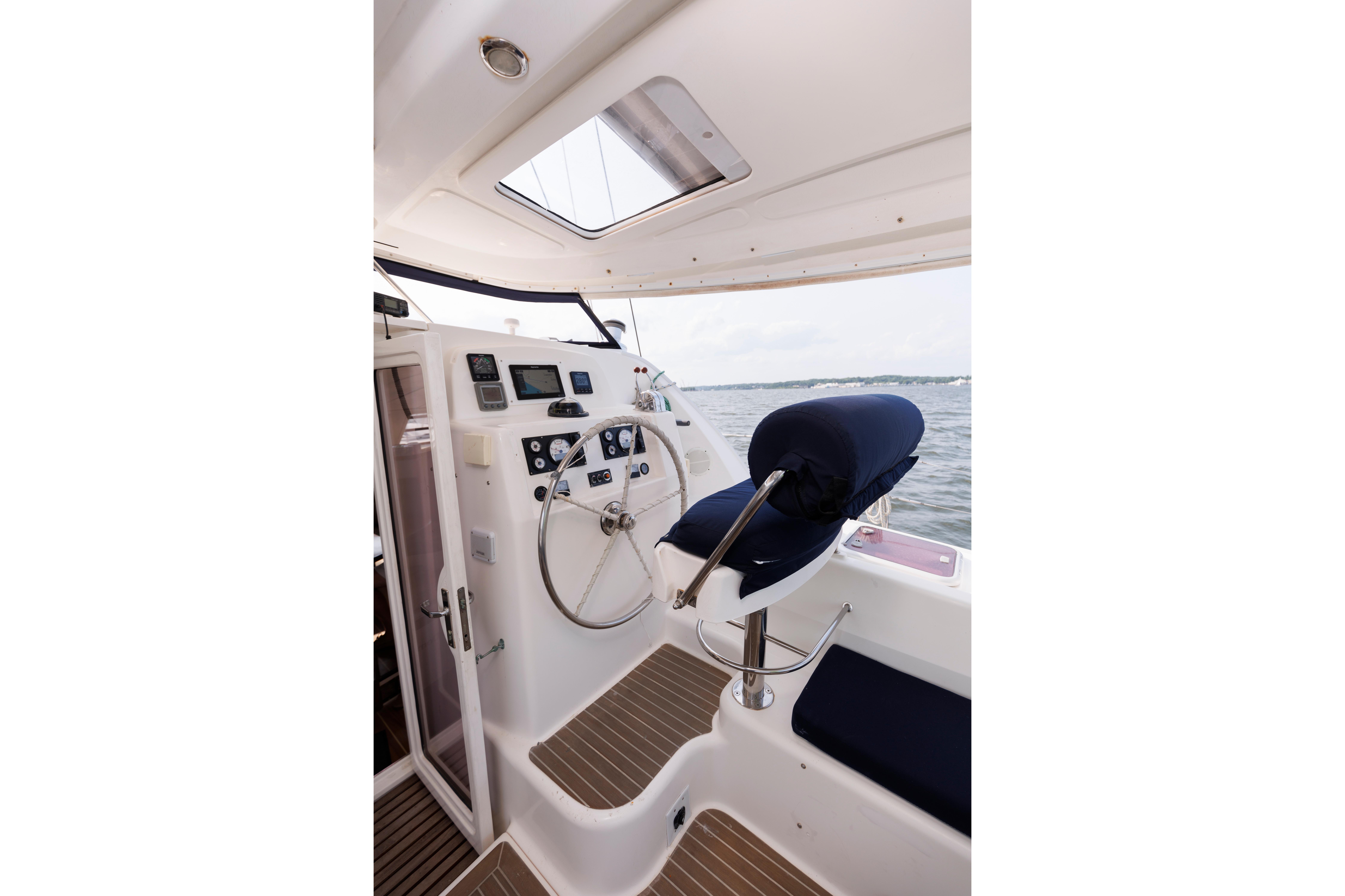 Interior helm of 2006 Leopard 43 yacht with steering wheel and navigation instruments.