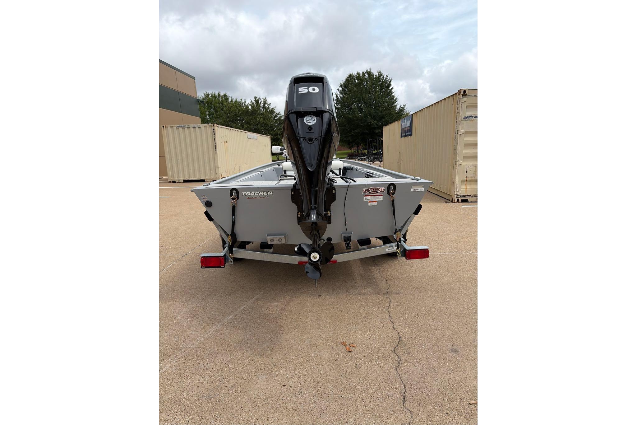 2026 Tracker Bass Tracker Classic CC boat, rear view with outboard motor, parked outdoors.