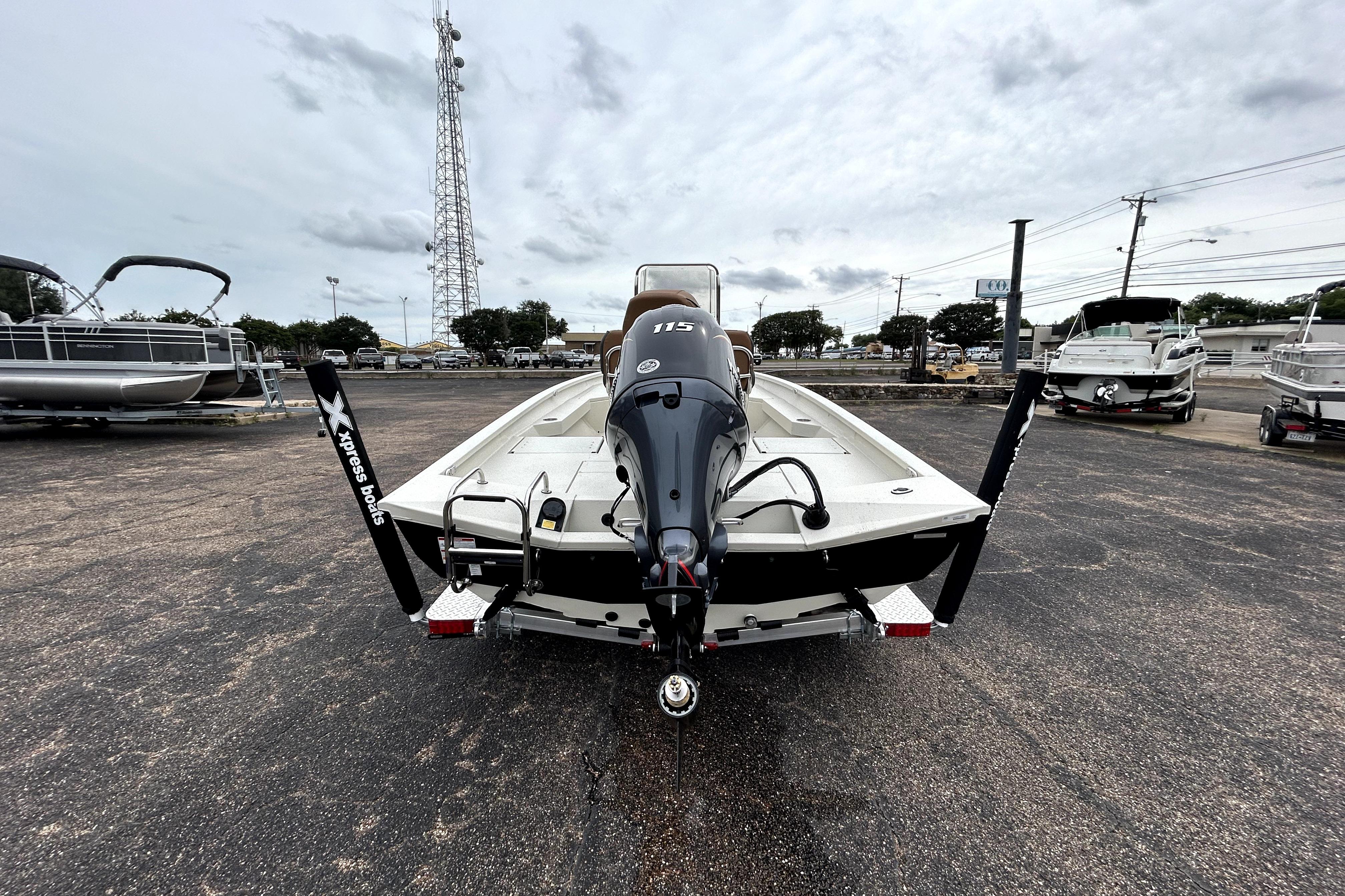 2026 Xpress H20B Bay boat with outboard motor in a parking lot.