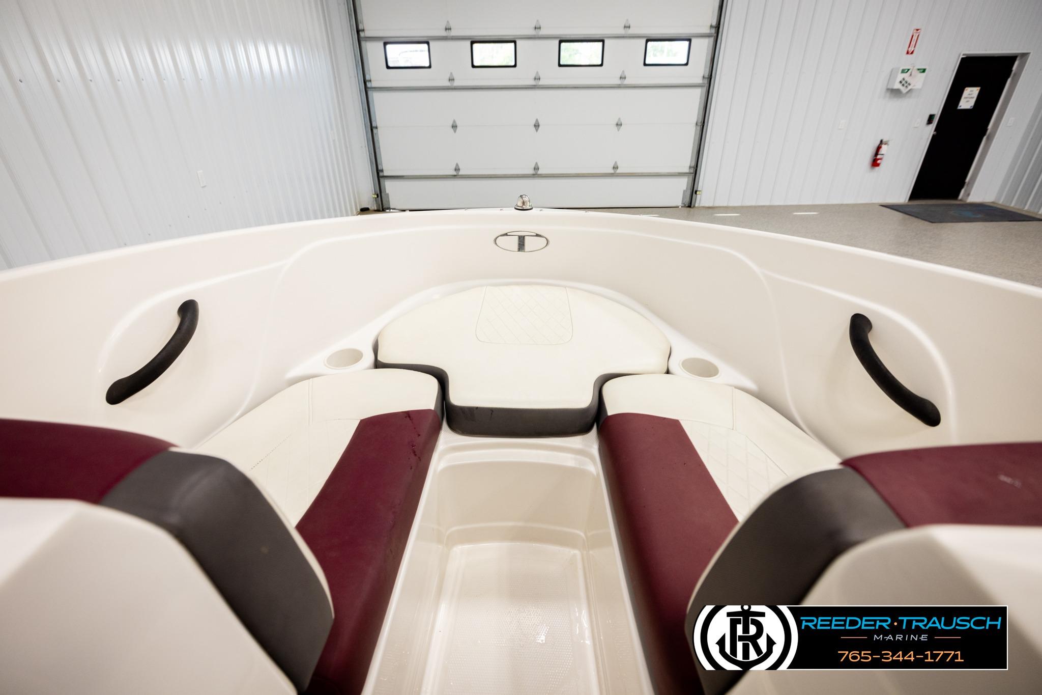 Interior view of a 2016 Tahoe 450 TS boat with maroon and white seating.