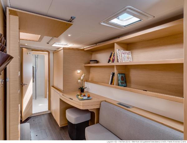 Interior of 2025 Lagoon 42 Millenium yacht with modern design and wooden finishes.