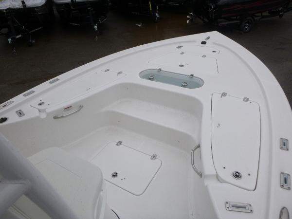 2025 Sea Pro 250 Bay boat deck with storage compartments and seating.