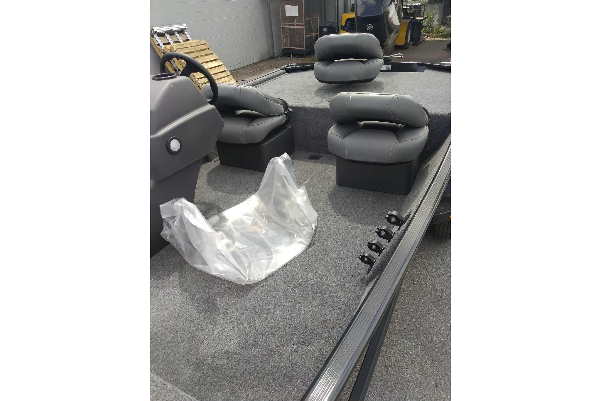2026 Tracker Bass Tracker Classic XL boat interior with gray seating and steering wheel.