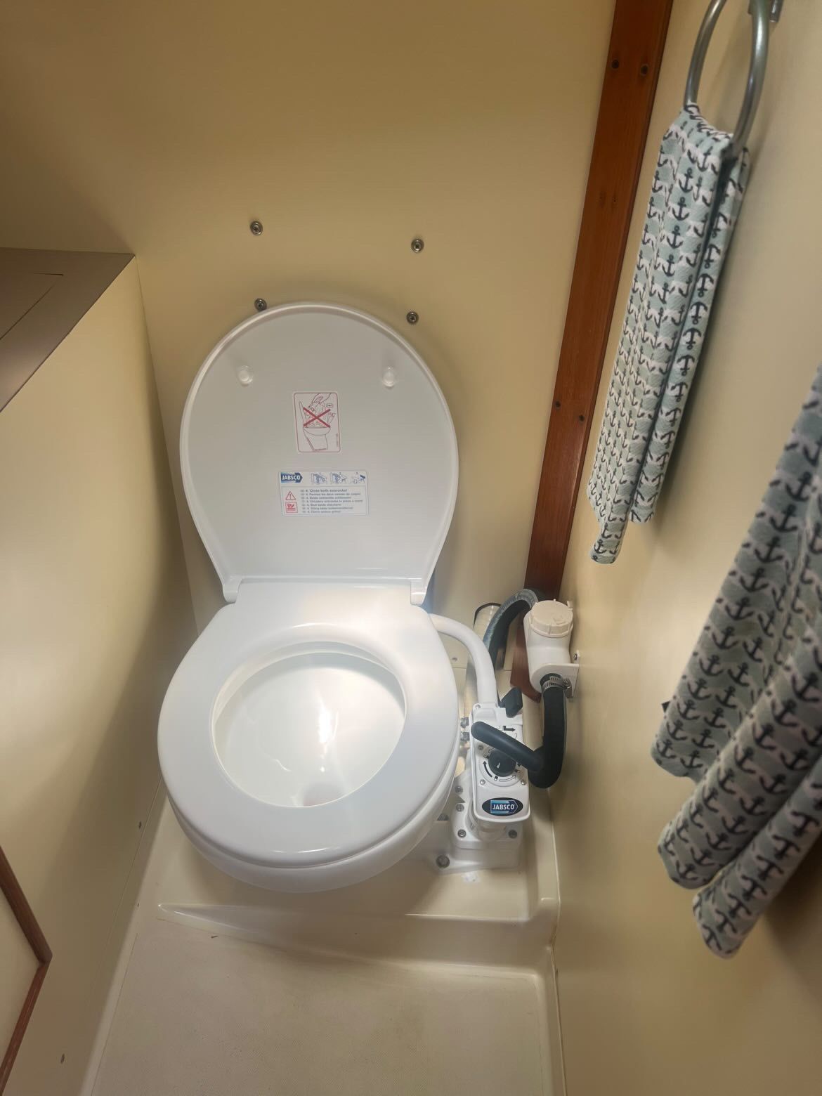 A bathroom with a toilet and a towel rack on the wall.