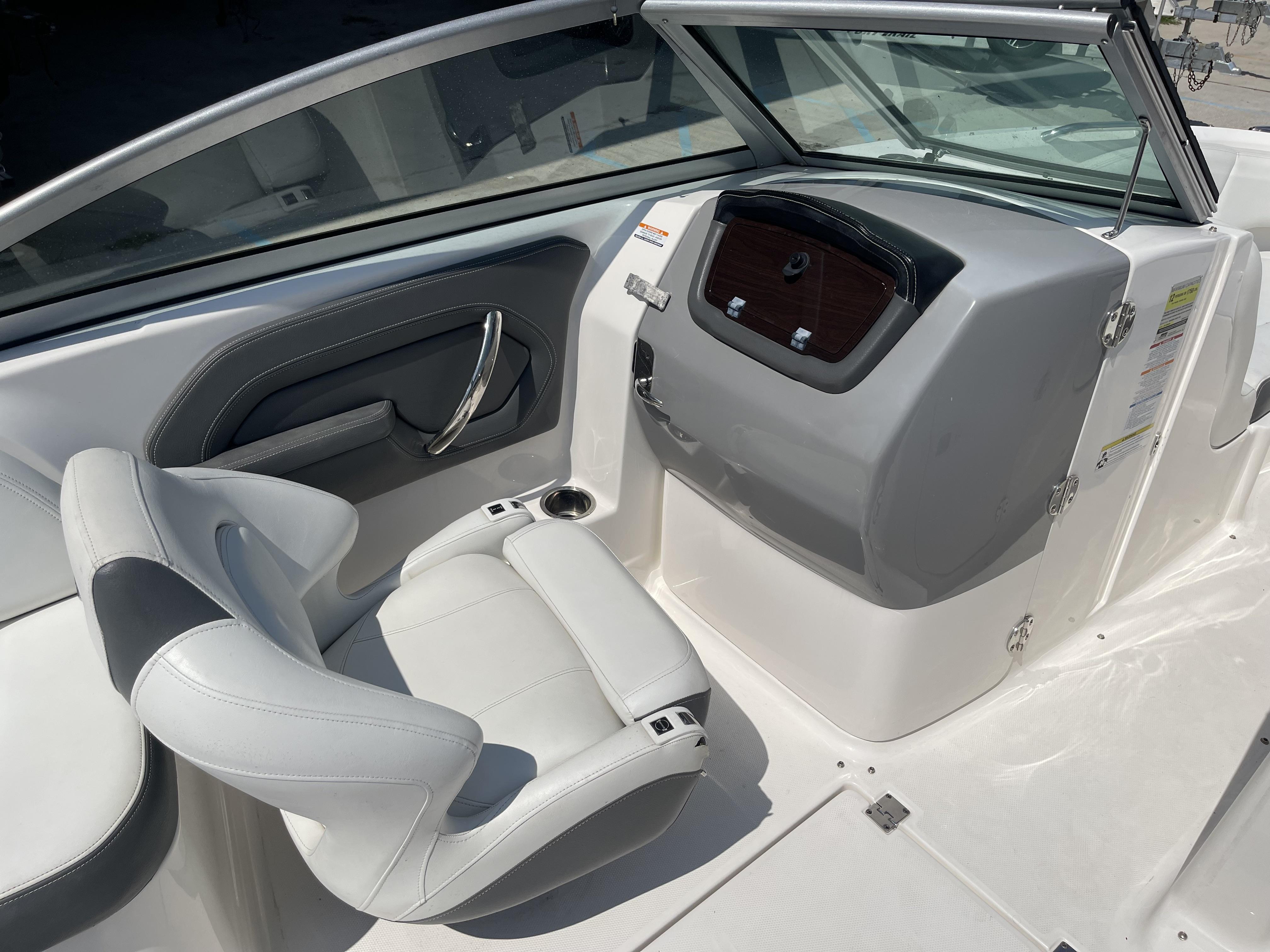2014 Chaparral Sunesta 224 boat interior with white seating and dashboard.