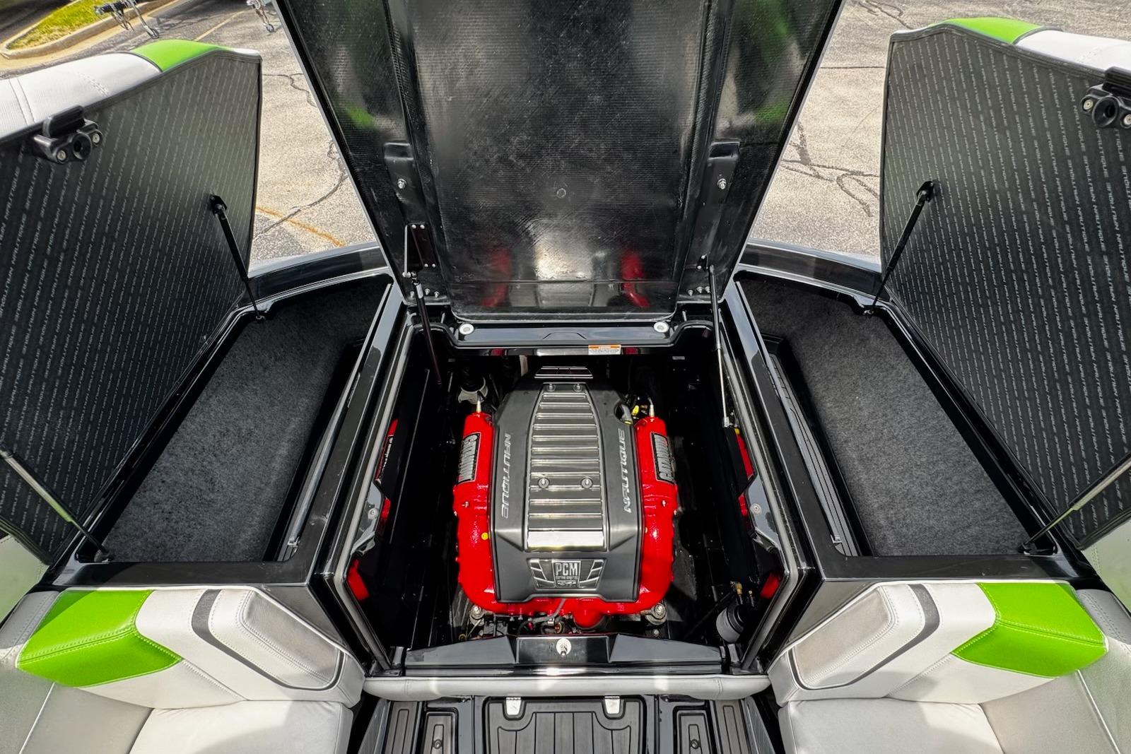 2014 Nautique Super Air Nautique G21 engine compartment with open hatches, showcasing powerful engine.