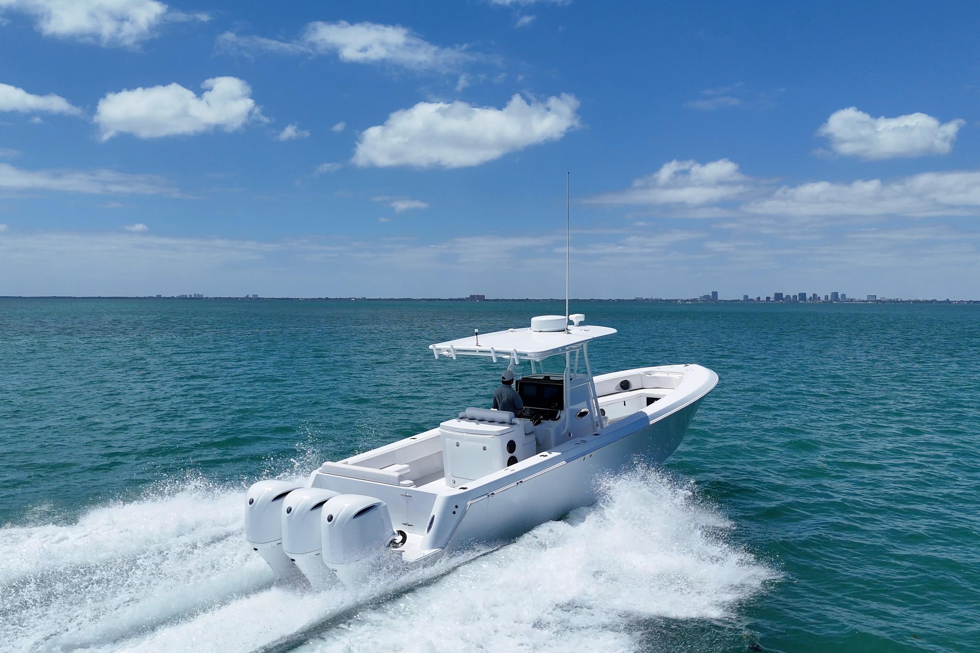 Contender 35 LS 2013 boat cruising on open water under a clear blue sky.