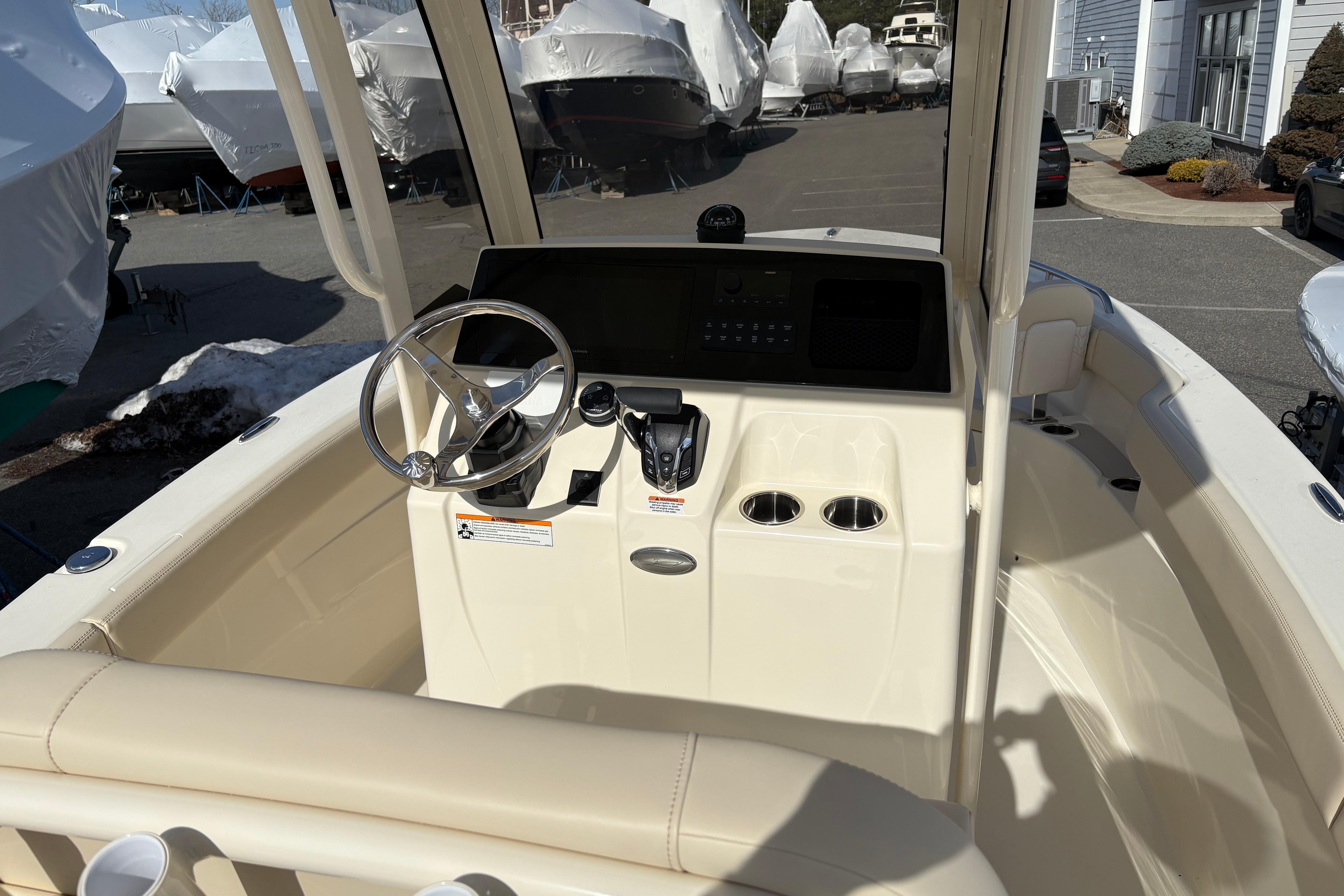 2026 Scout 220 XSF boat cockpit with steering wheel and control panel.