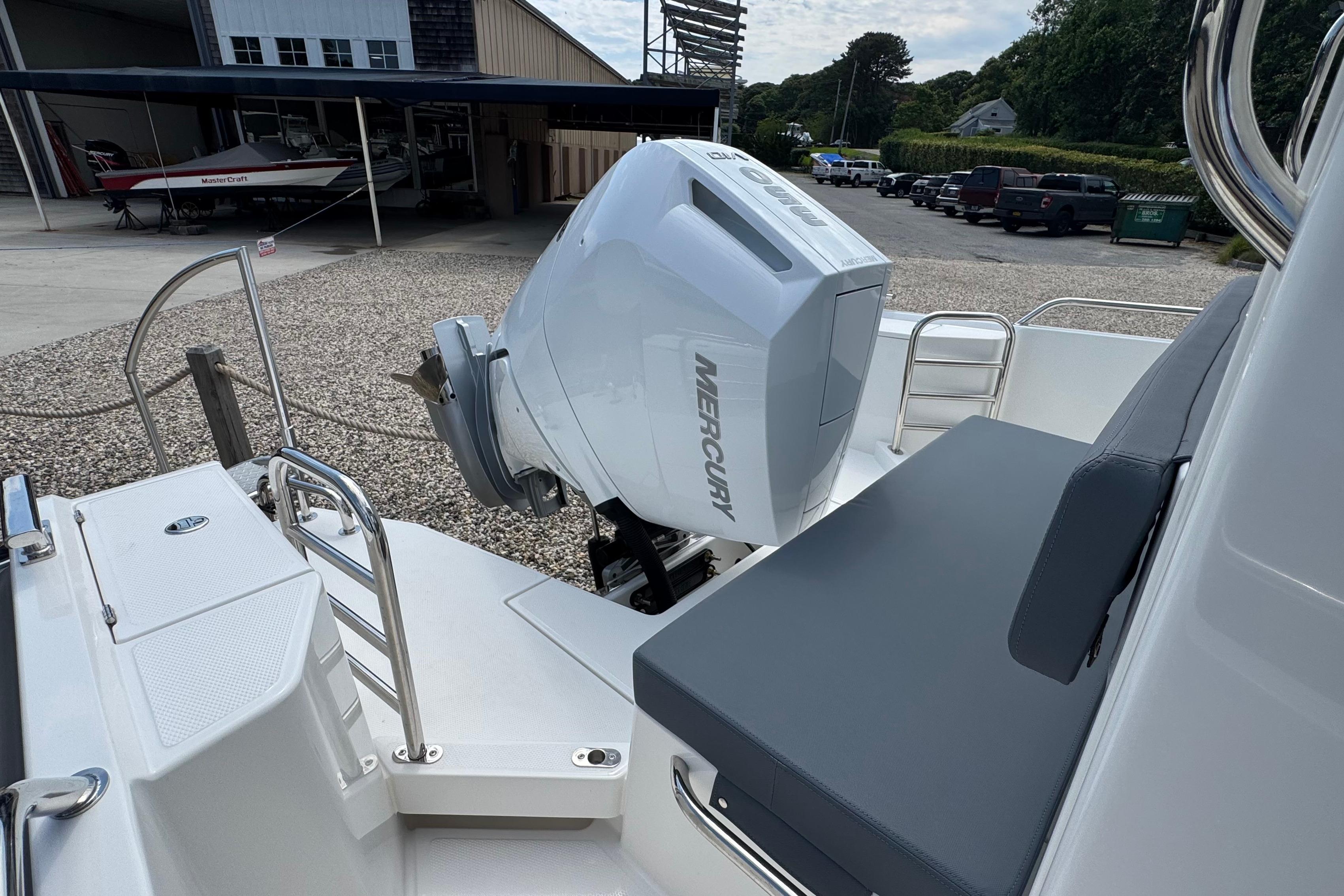 The image shows the stern of a Nimbus Commuter 9 with a Mercury outboard motor.