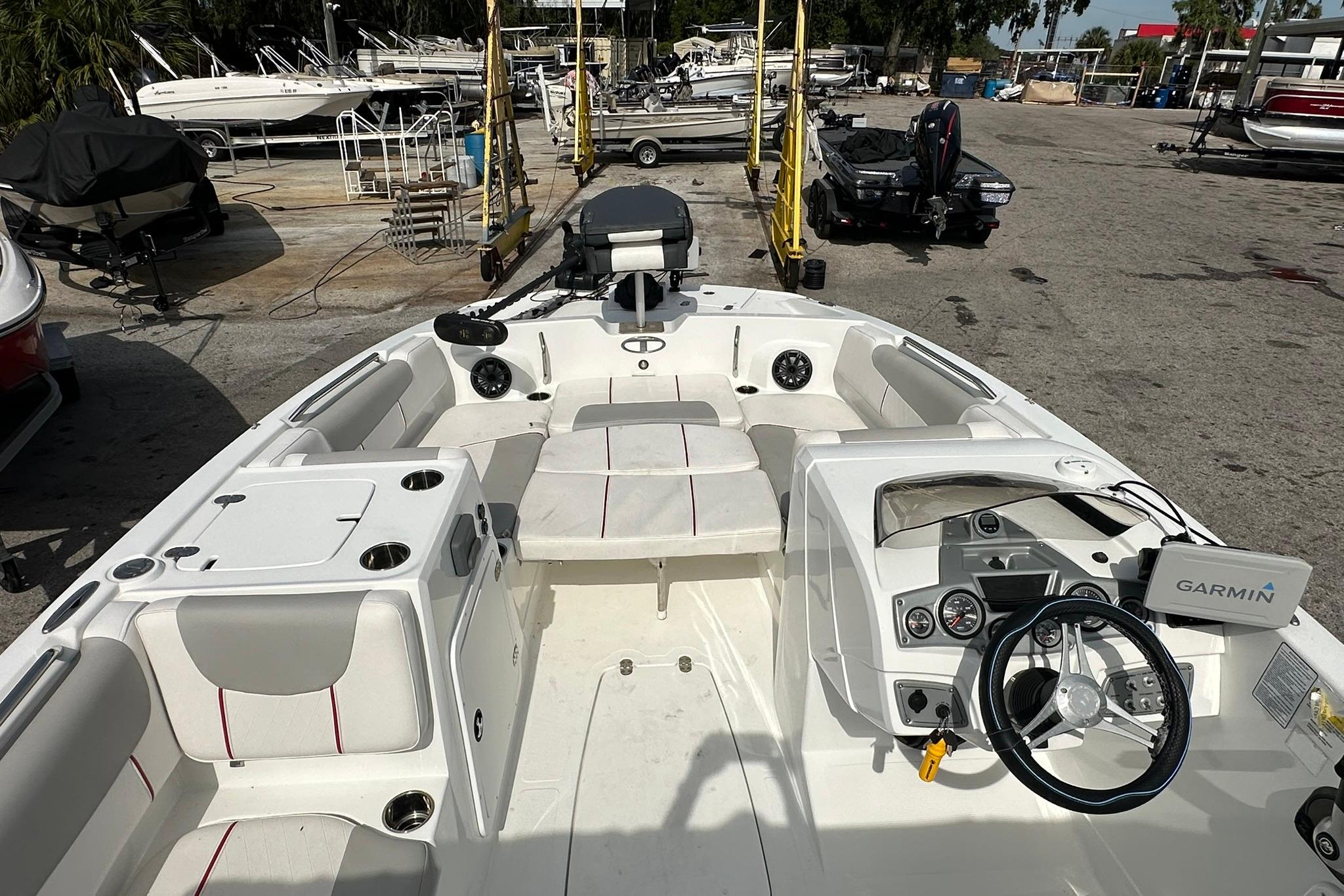 2021 Tahoe 2150 boat interior with Garmin navigation, docked at a marina.
