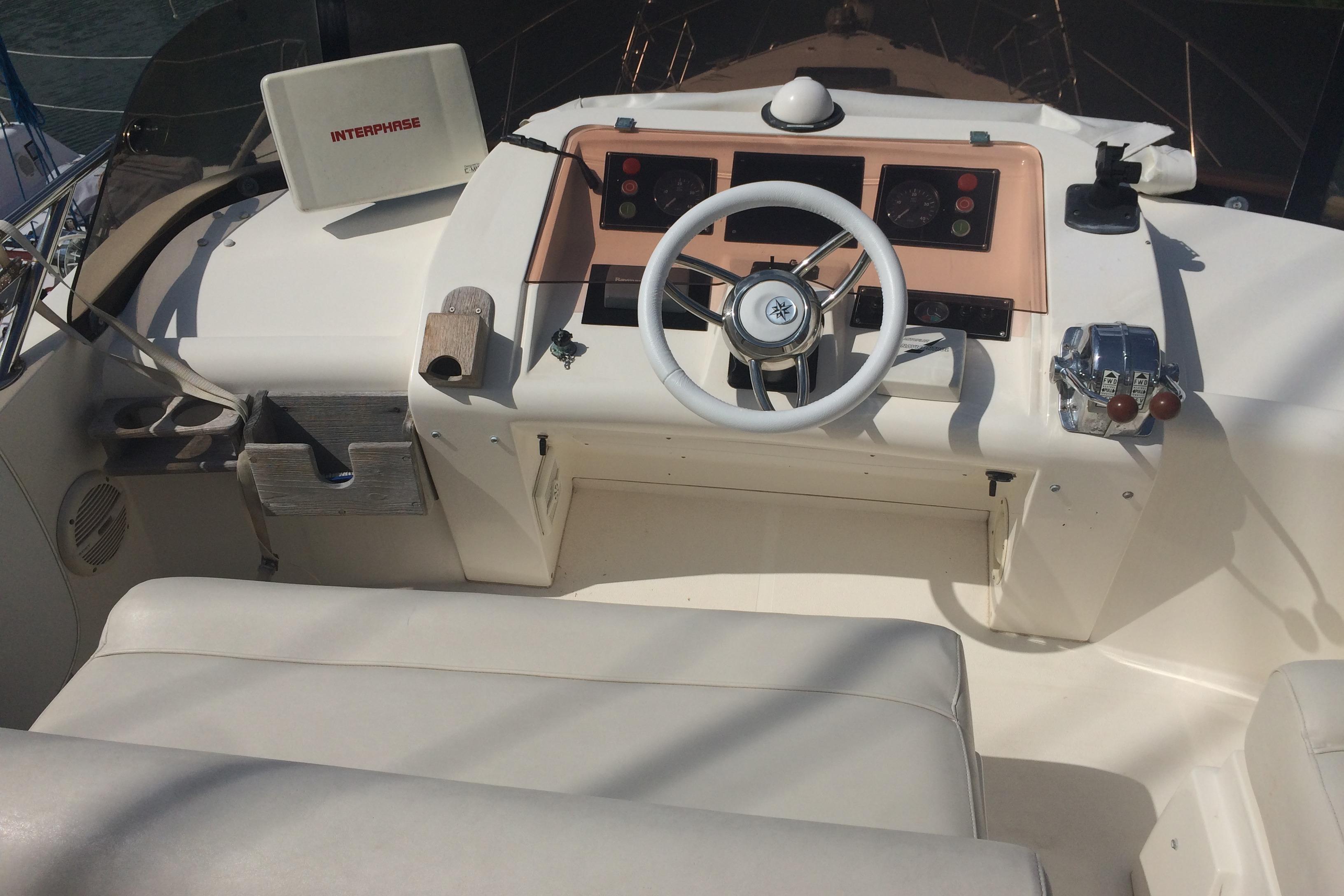 1994 Fairline Phantom 37 yacht helm with steering wheel and control panel.