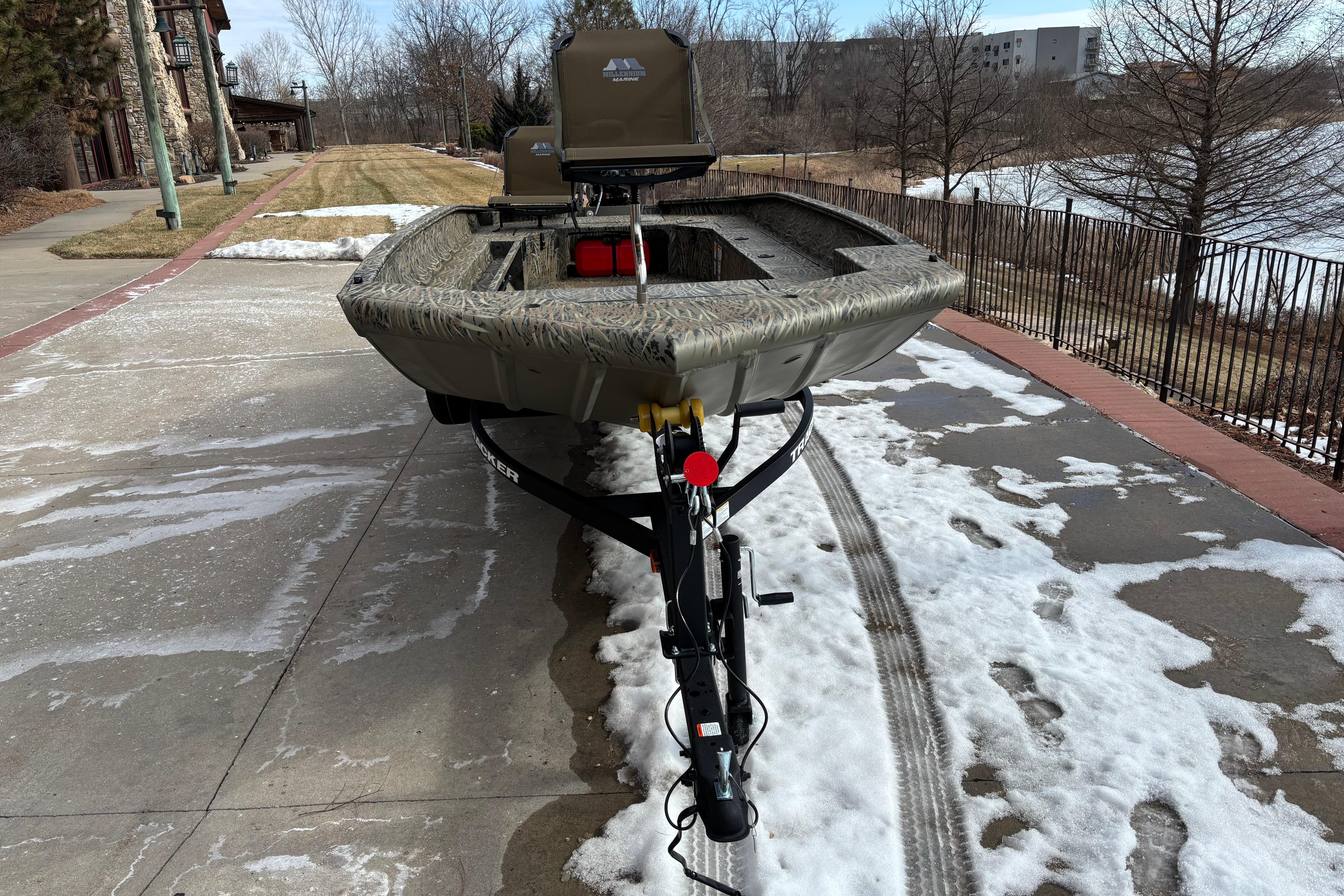 2026 Tracker Grizzly 1756 T Marsh boat on snowy driveway, ready for adventure.