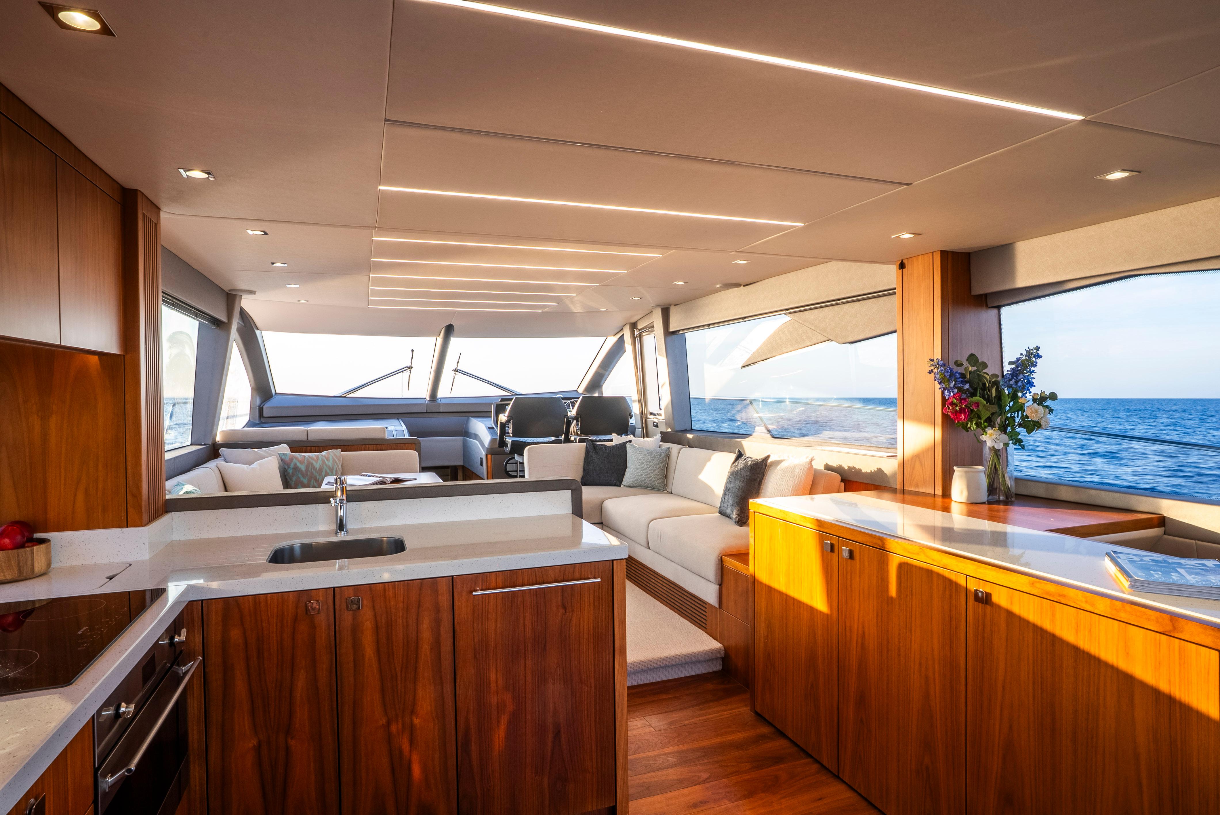 Luxurious interior of 2017 Sunseeker Manhattan 66 yacht with modern kitchen and ocean view.