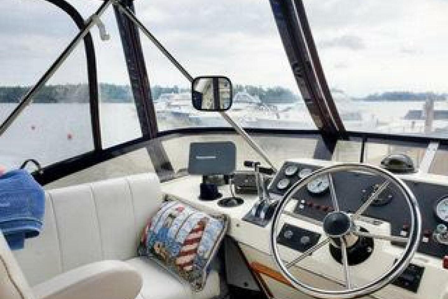 1986 Bayliner 3270 Motoryacht helm with steering wheel and navigation instruments.