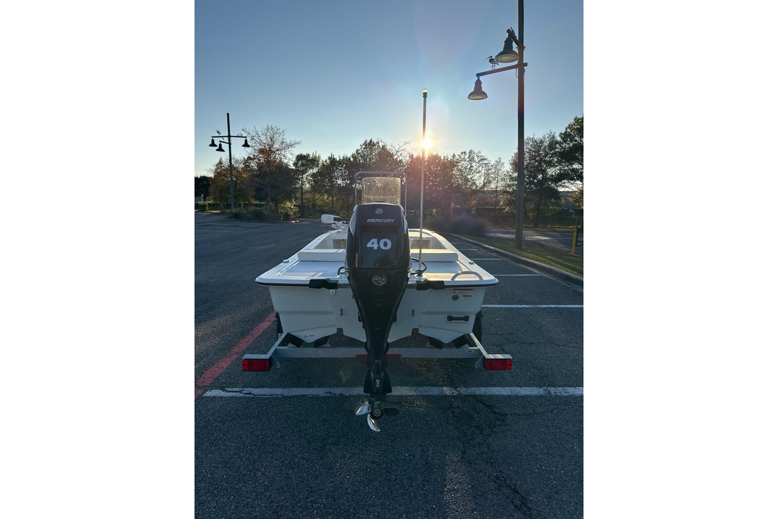 2026 Mako Pro Skiff 13 CC boat with Mercury 40 engine at sunset.